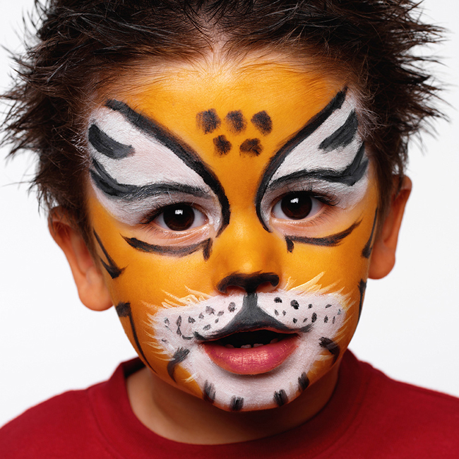  Boy (3-5) with face painted as tiger, close-up, portrait 