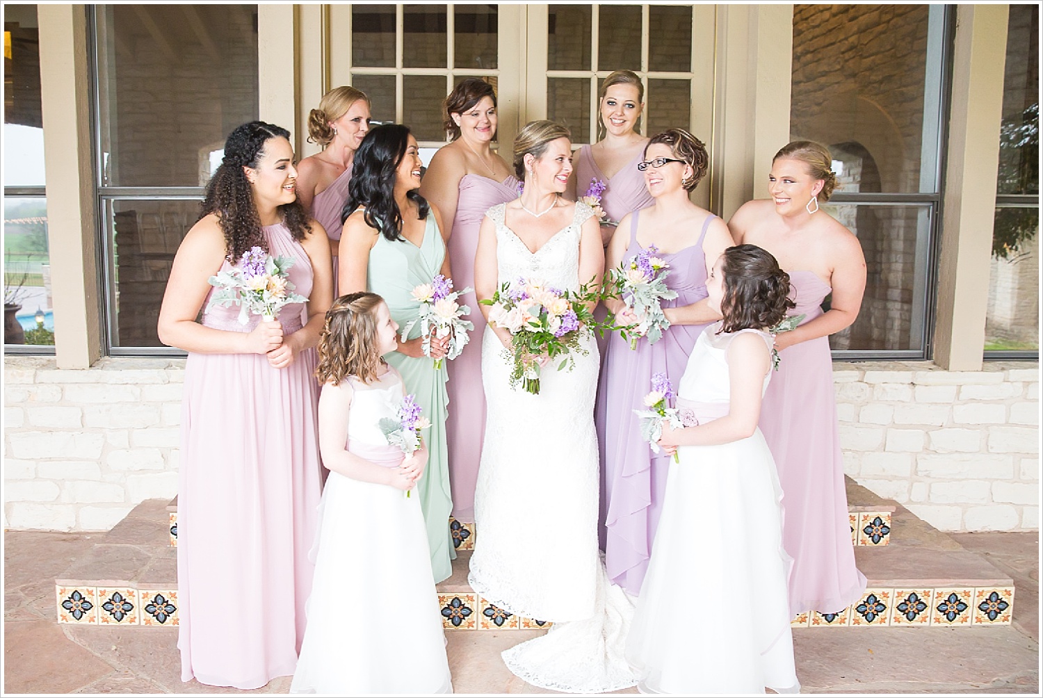 Bride and bridesmaids together on steps of porch at La Rio Mansion