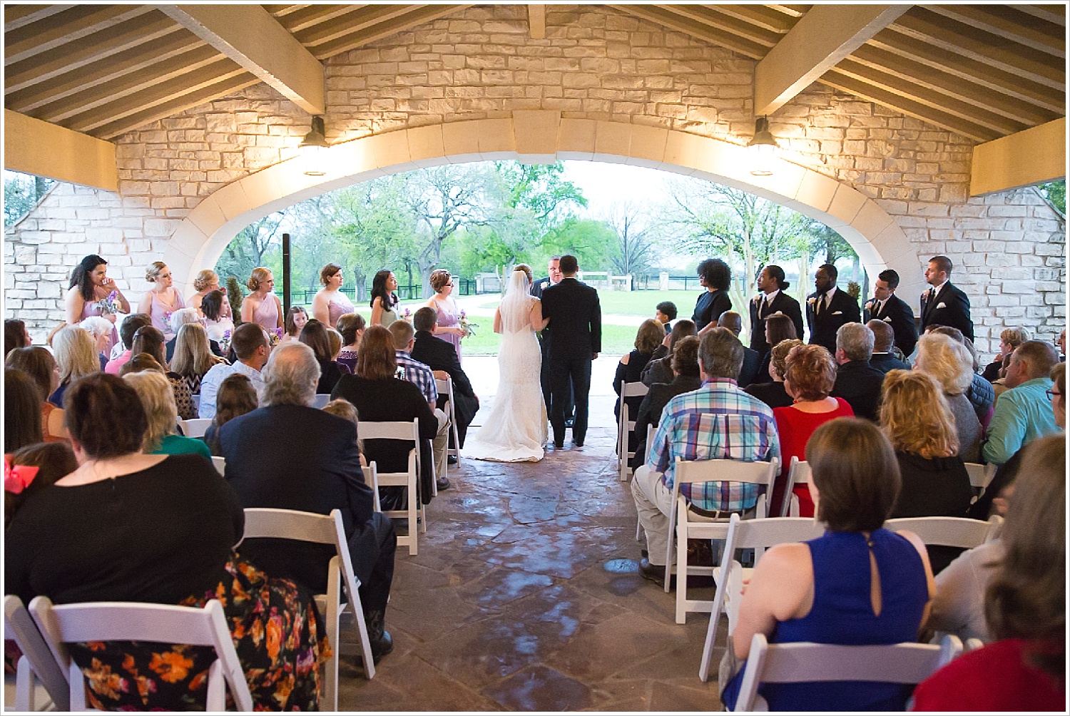 Rainy wedding ceremony under covered driveway at La Rio Mansion in Belton, Texas