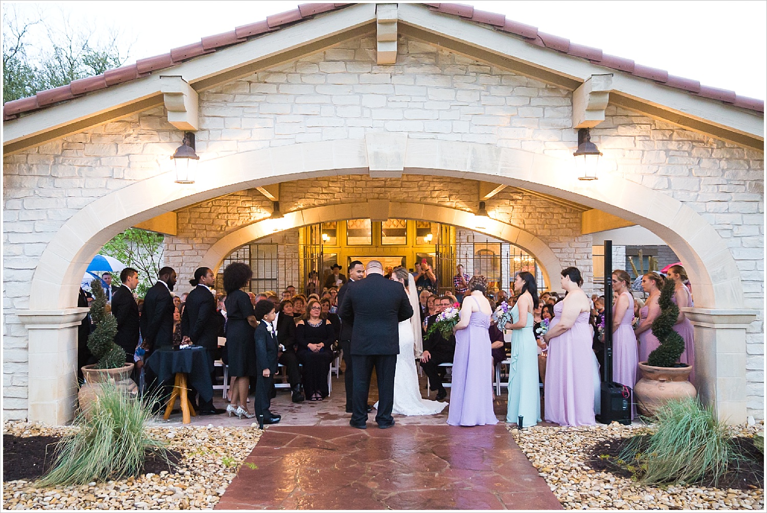 Wedding ceremony during rainstorm at La Rio Mansion in Belton, Texas