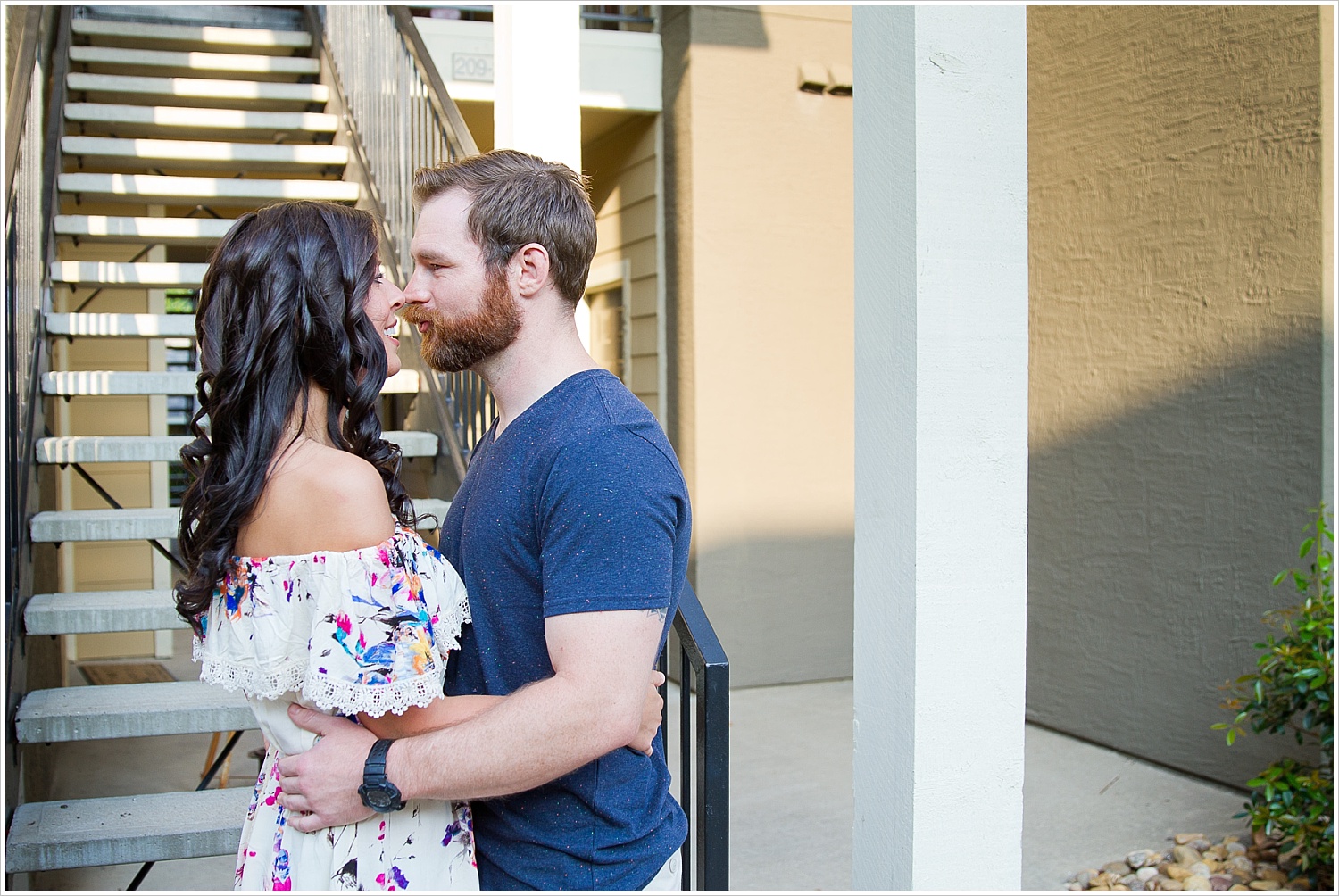 Randell and Fawn hold one another outside the apartment complex they met at during an engagement photography session in Frisco, Texas by Texas wedding photographers Jason & Melaina Photography, www.jasonandmelaina.com