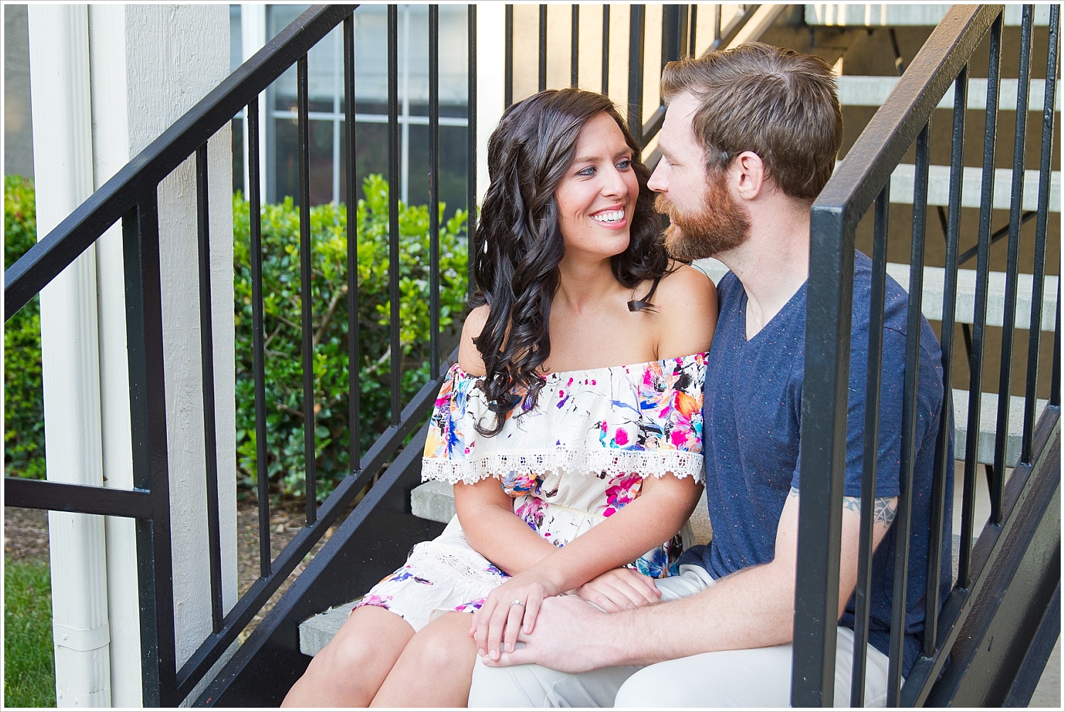 Randell & Fawn sit together on the stairs of their old apartment complex at an engagement photography session in Frisco, Texas by Texas wedding photographers Jason & Melaina Photography, www.jasonandmelaina.com