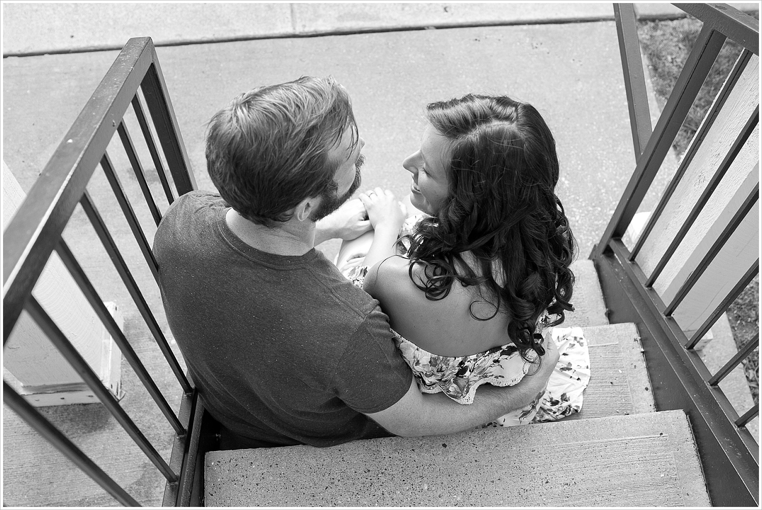 Randell & Fawn sit together on the stairs of their old apartment complex at an engagement photography session in Frisco, Texas by Texas wedding photographers Jason & Melaina Photography, www.jasonandmelaina.com