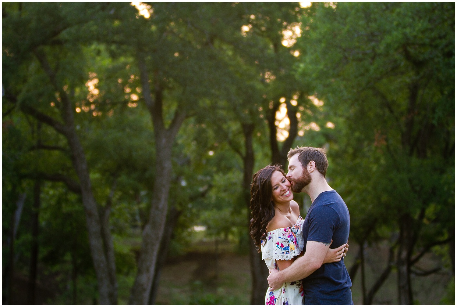 Randell & Fawn embrace in the park where Randell proposed at an engagement photography session in Frisco, Texas by Texas wedding photographers Jason & Melaina Photography, www.jasonandmelaina.com