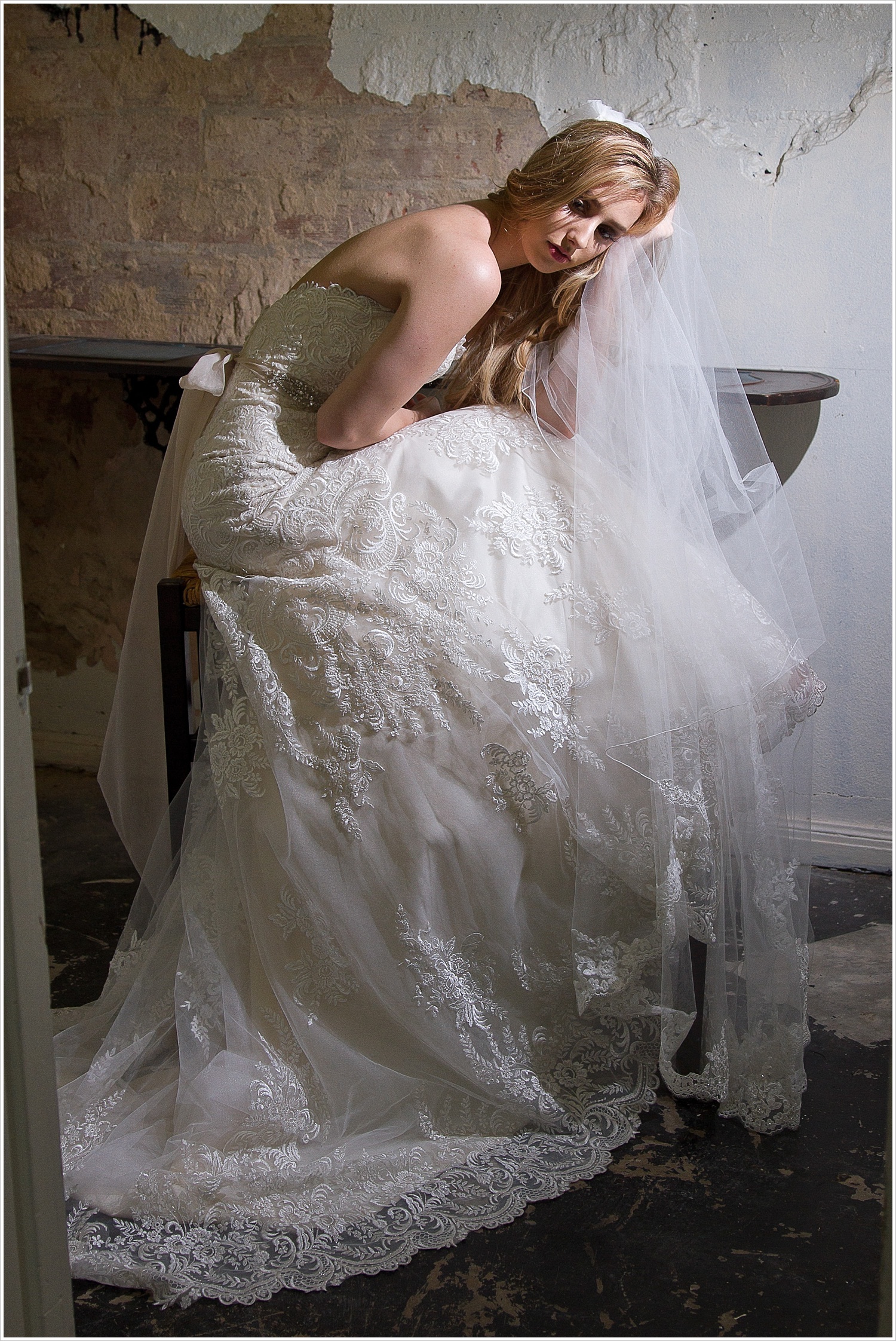 Model poses in gorgeous _______ wedding gown in the Hair & Beauty Art Studio in Waco, Texas. Photography by Jason & Melaina Photography, Texas wedding photographers. www.jasonandmelaina.com