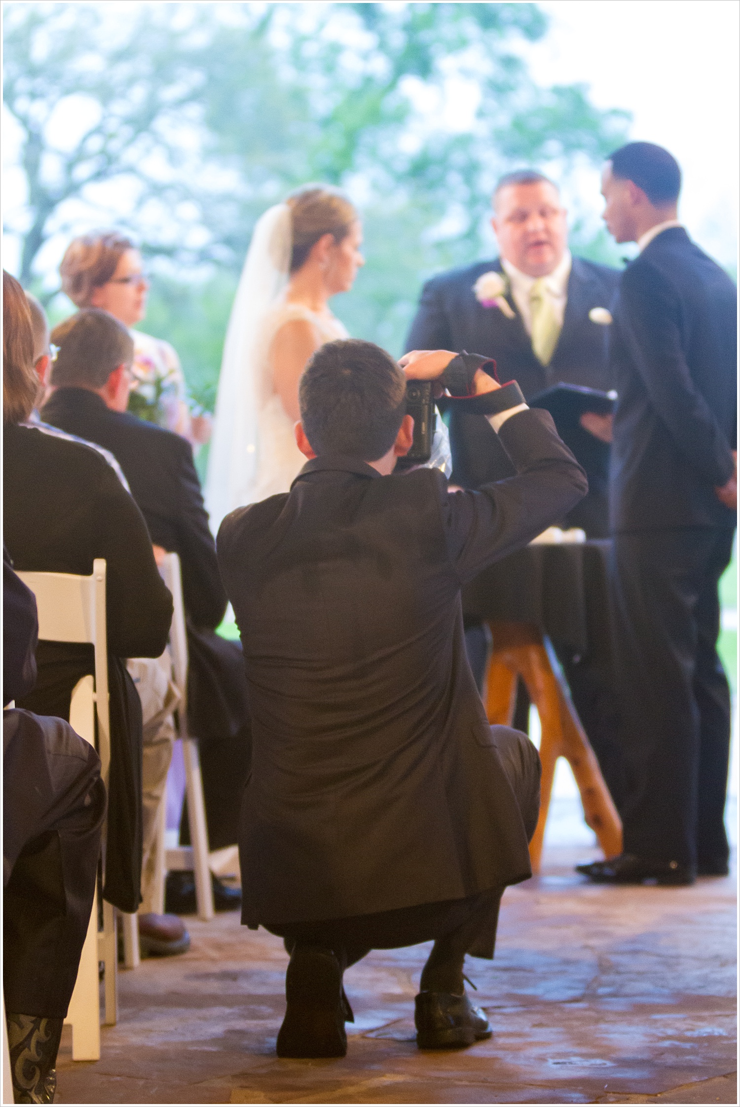 A photographer in the aisle during a wedding ceremony-Should you have an unplugged wedding?, written by Texas Wedding Photographers, Jason & Melaina Photography-www.jasonandmelaina.com