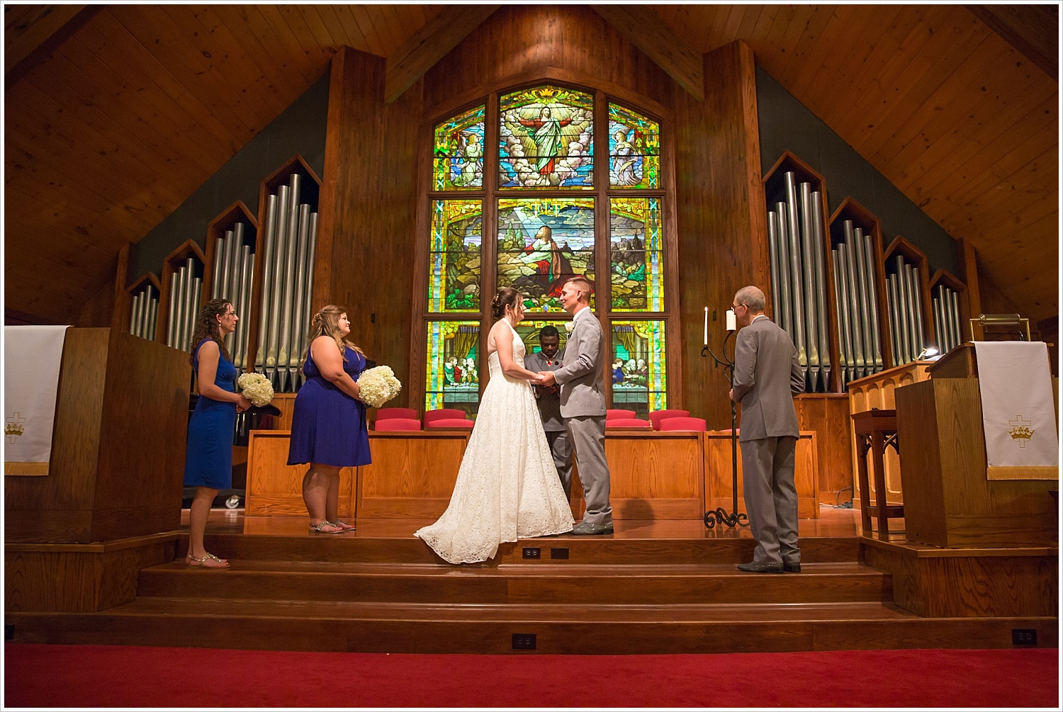 Bride and groom in wedding ceremony in front of gorgeous stained glass backdrop at Central Presbyterian Church in Waco/Woodway, TX - Jason & Melaina Photography, www.jasonandmelaina.com