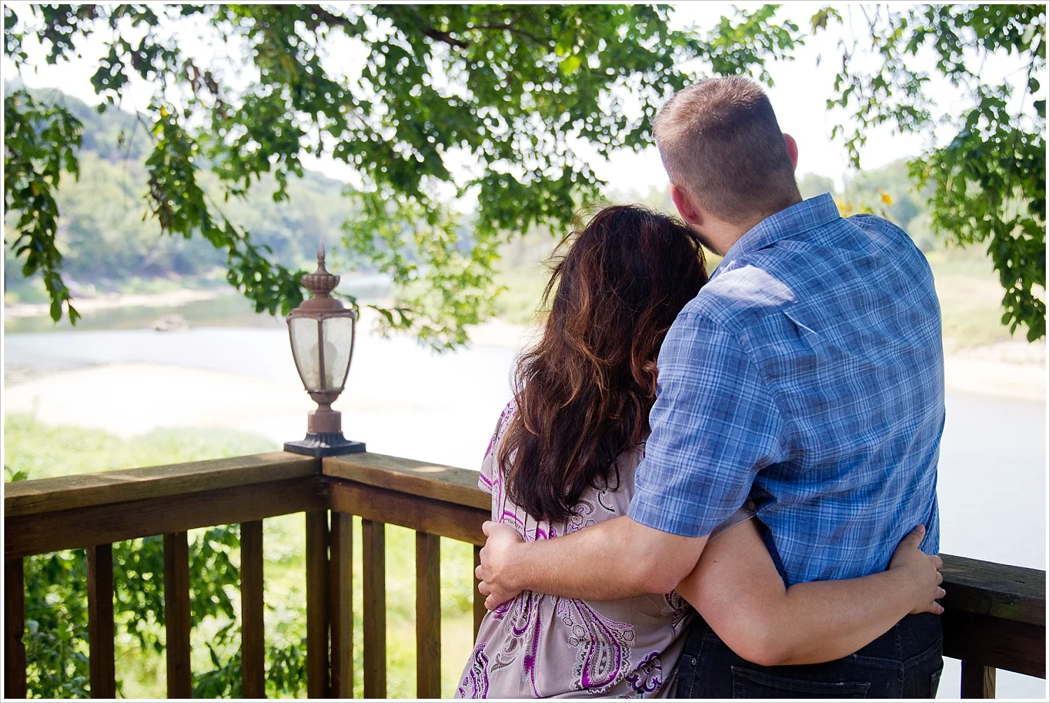 Charles & Alex pose on the deck overlooking the Brazos River during their engagement portraits at Brazos Bluffs Ranch in Waco, Texas - Jason & Melaina Photography, www.jasonandmelaina.com
