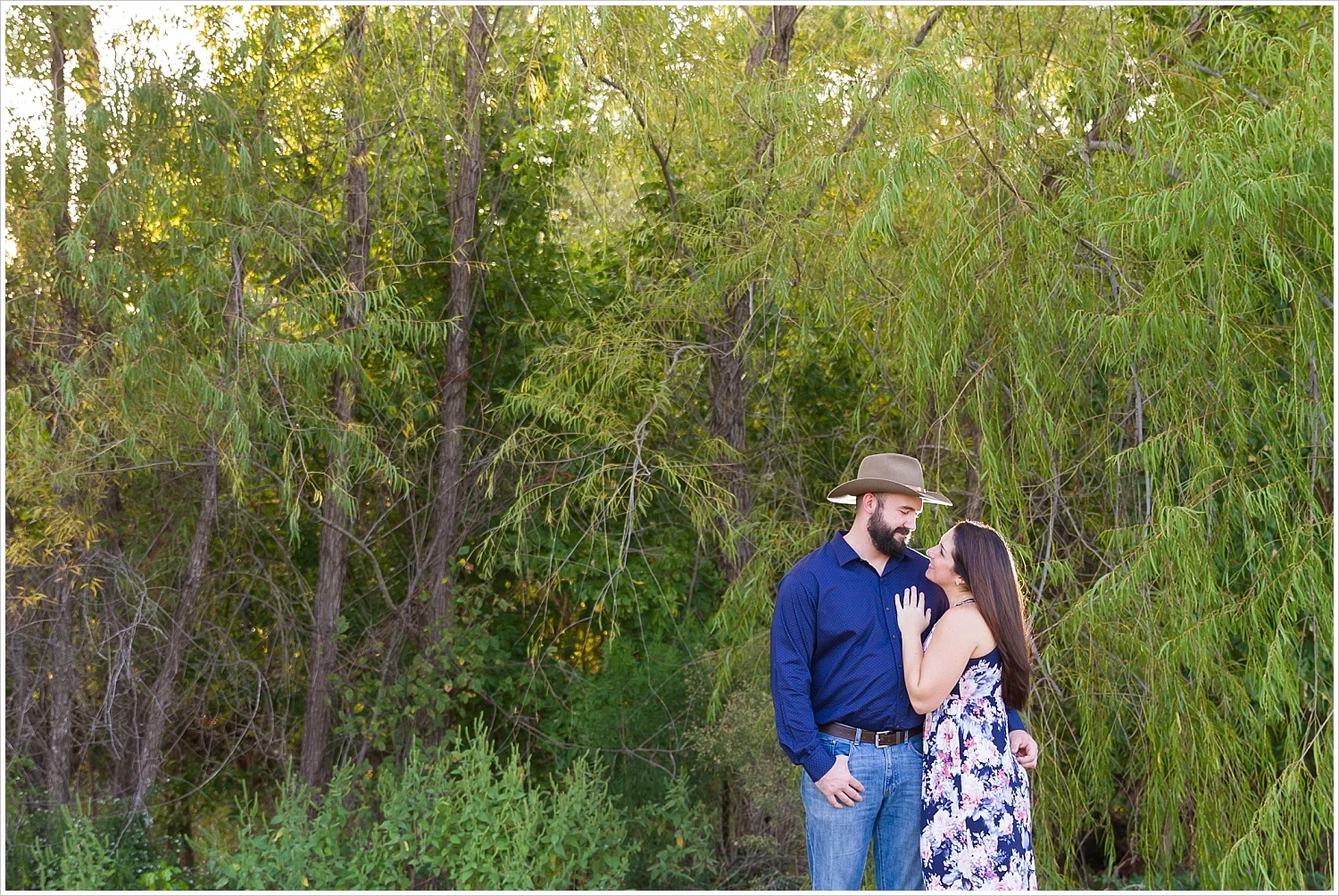 A bride looks up and smiles at her fiance during engagement photo session in Waco, Texas, Jason & Melaina Photography - www.jasonandmelaina.com