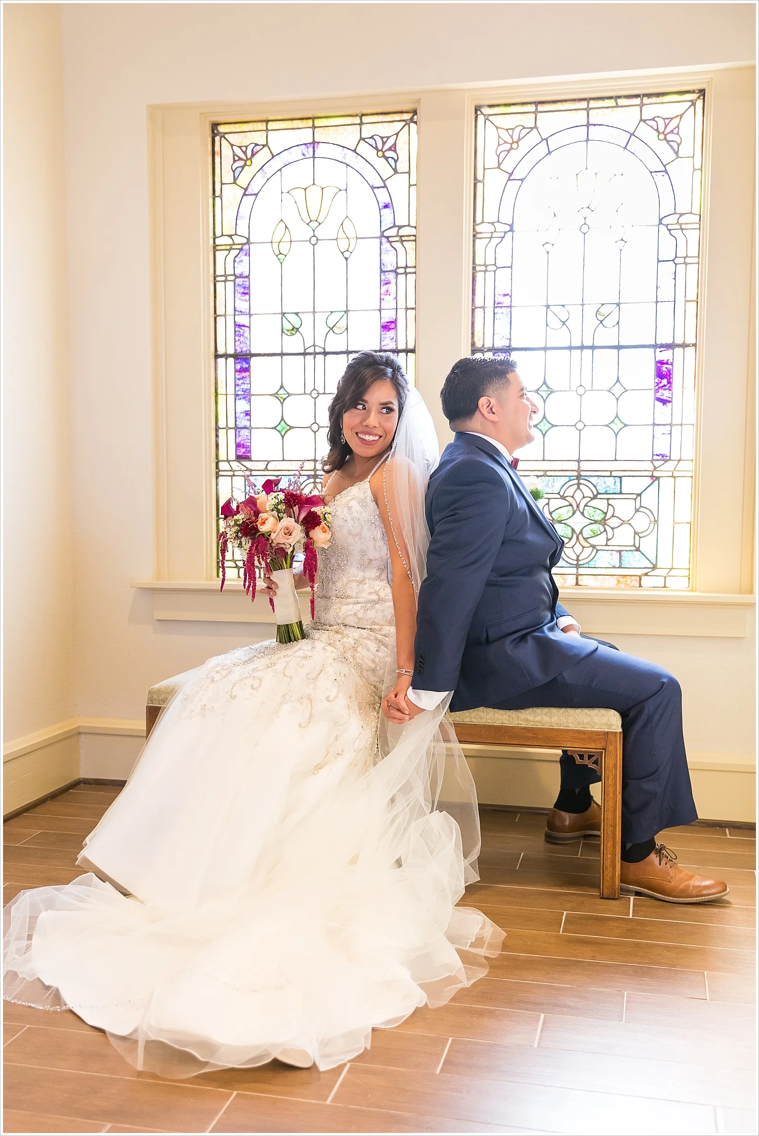 A bride and groom hold hands during a "first touch" at their wedding at FBC Waco - Jason & Melaina Photography - www.jasonandmelaina.com