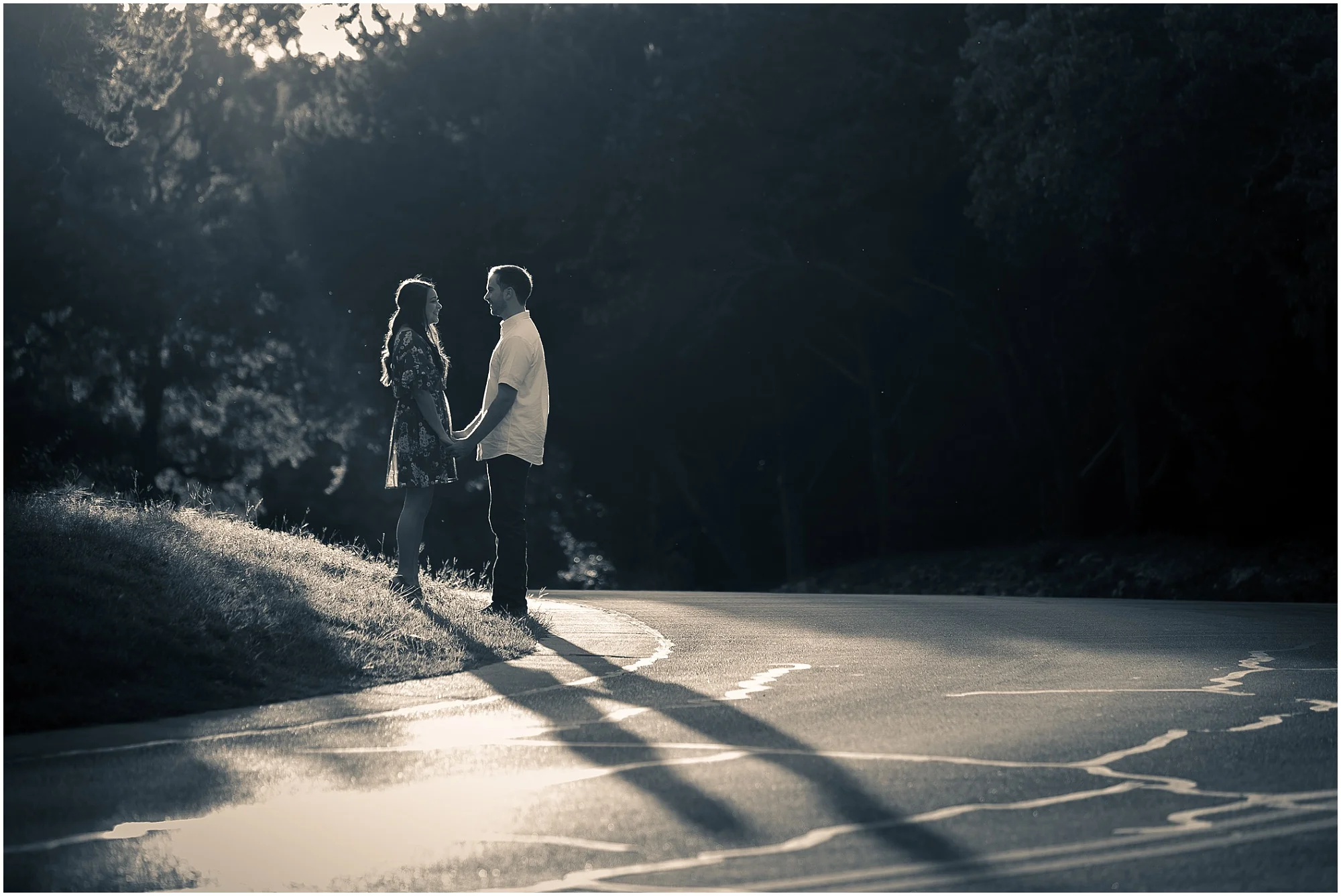 A groom and his fiance hold hands in the sunlight near a road in Cameron Park - Jason & Melaina Photography