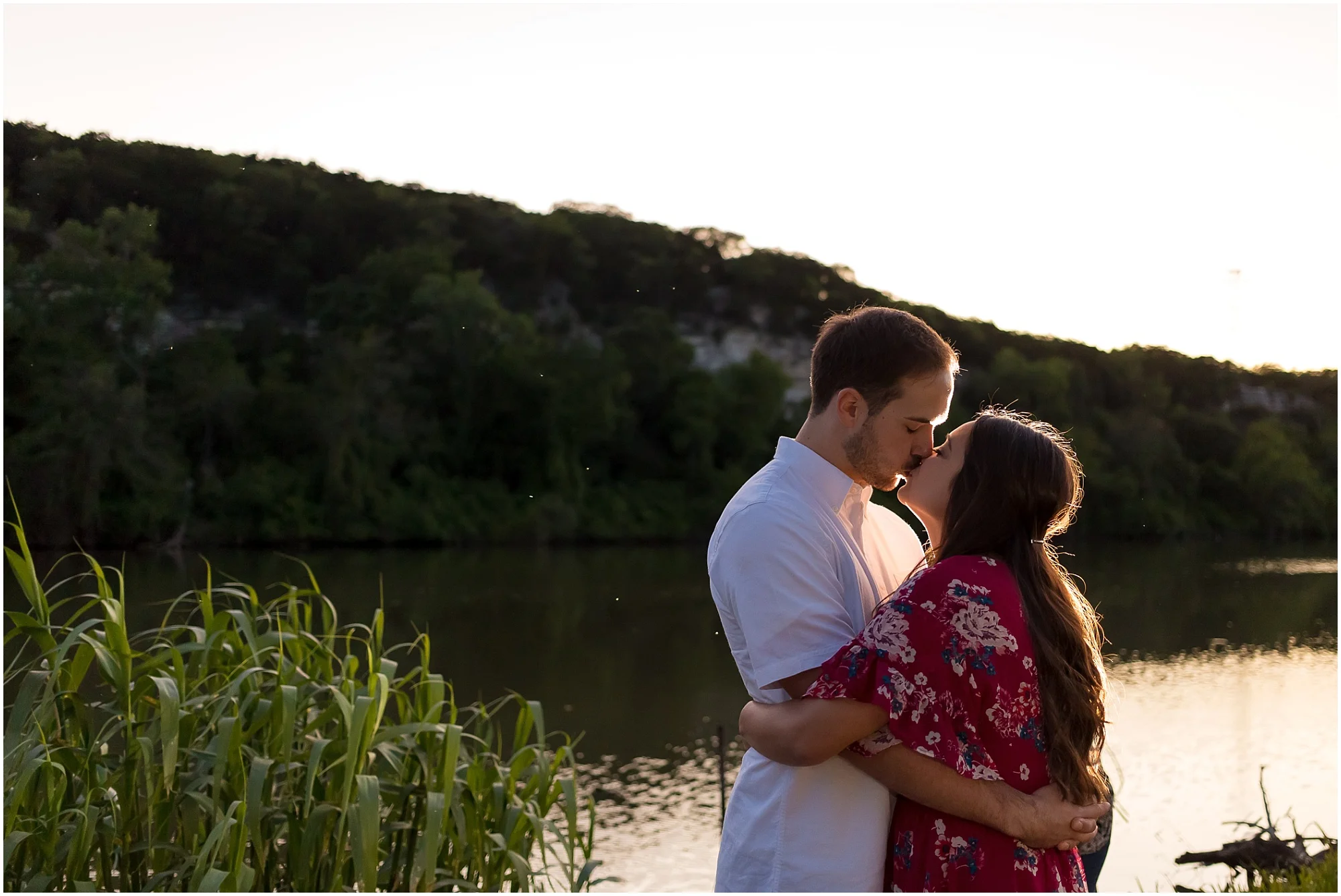 A couple kisses as the sun sets over the Bosque River during their engagement session - Waco, Texas - Jason & Melaina Photography - www.jasonandmelaina.com