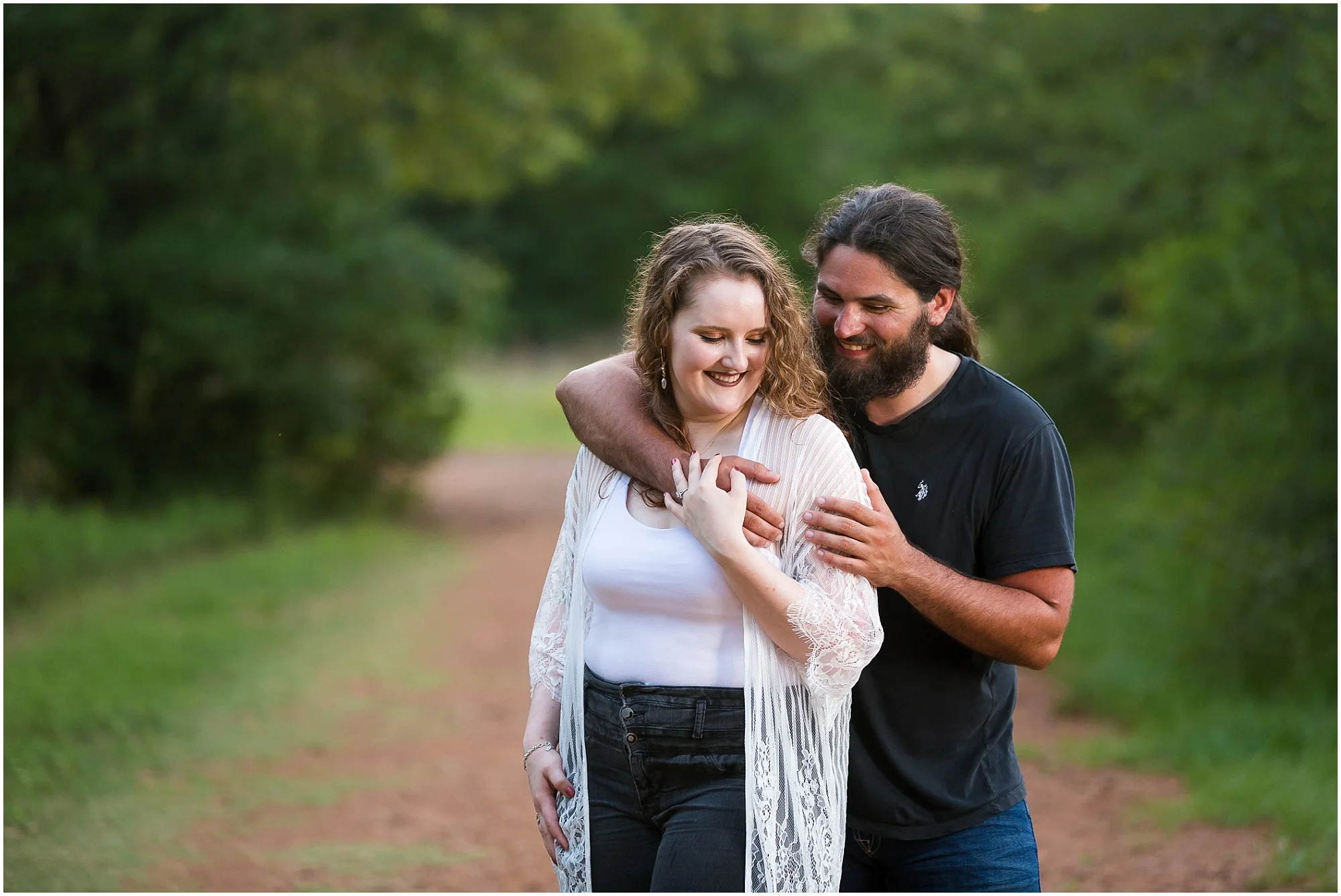A man hugs his fiance during their engagement session at Lick Creek Park in College Station, Tx - Jason & Melaina Photography - www.jasonandmelaina.com