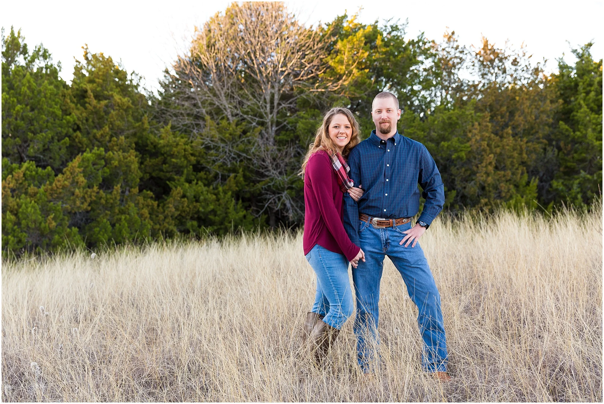 Couple holds one another in field of tall grass - Waco, Texas