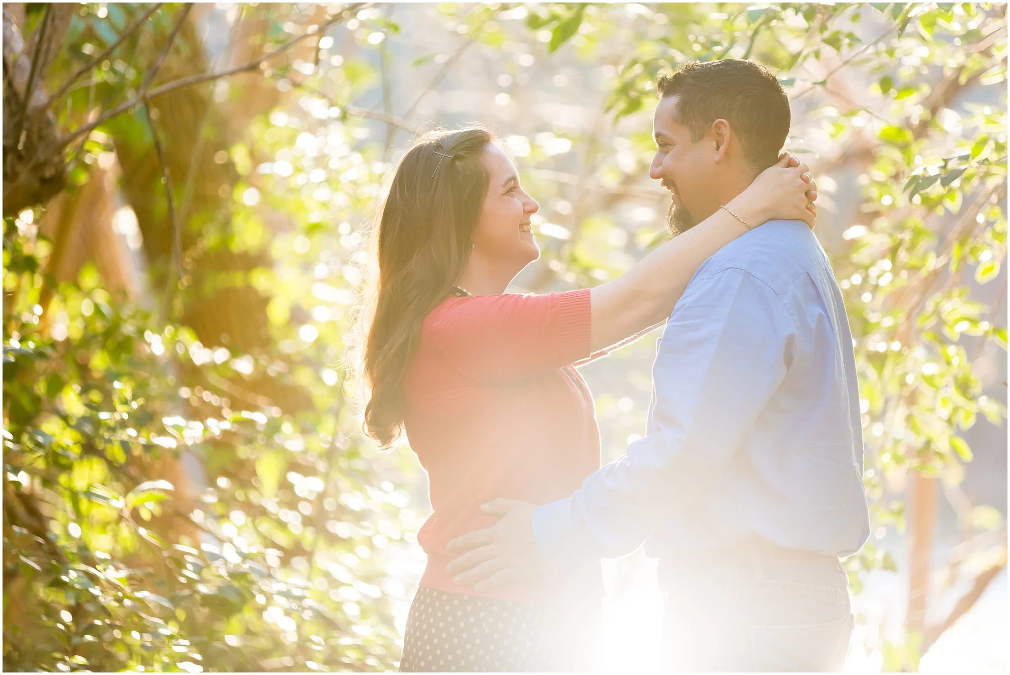 A couple laughs and hugs in the sunlight by the Brazos River in Waco, Texas - Jason & Melaina Photography - www.jasonandmelaina.com