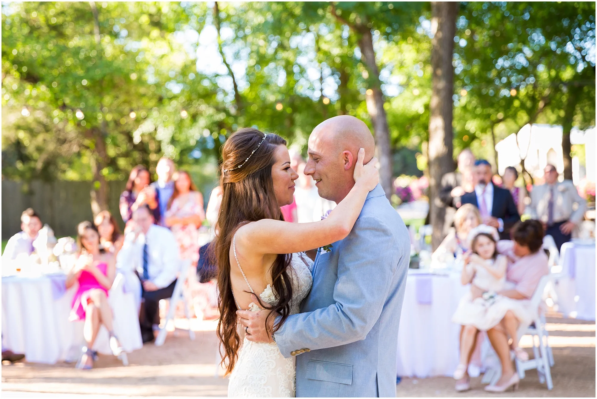 A bride holds her groom’s head and looks into his eyes while they dance during their wedding reception at Gathering Oaks Retreat | Jason & Melaina Photography | www.jasonandmelaina.com