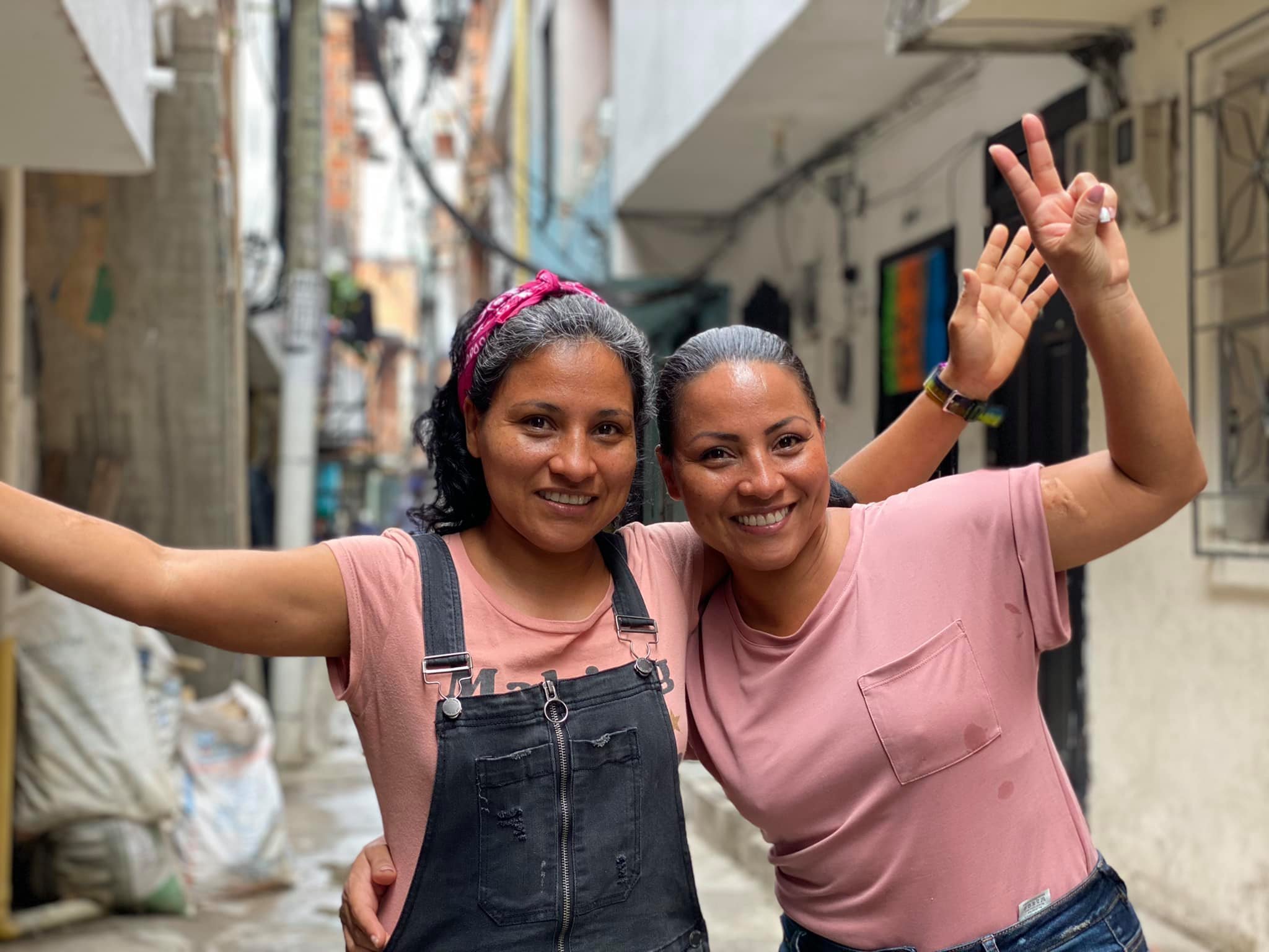  Angela Holguin (right) and her twin sister Cielo drive several social initiatives in their barrio, including the funding and building of a community center as well as bringing in visitors to introduce travelers to the issues and potential in the com