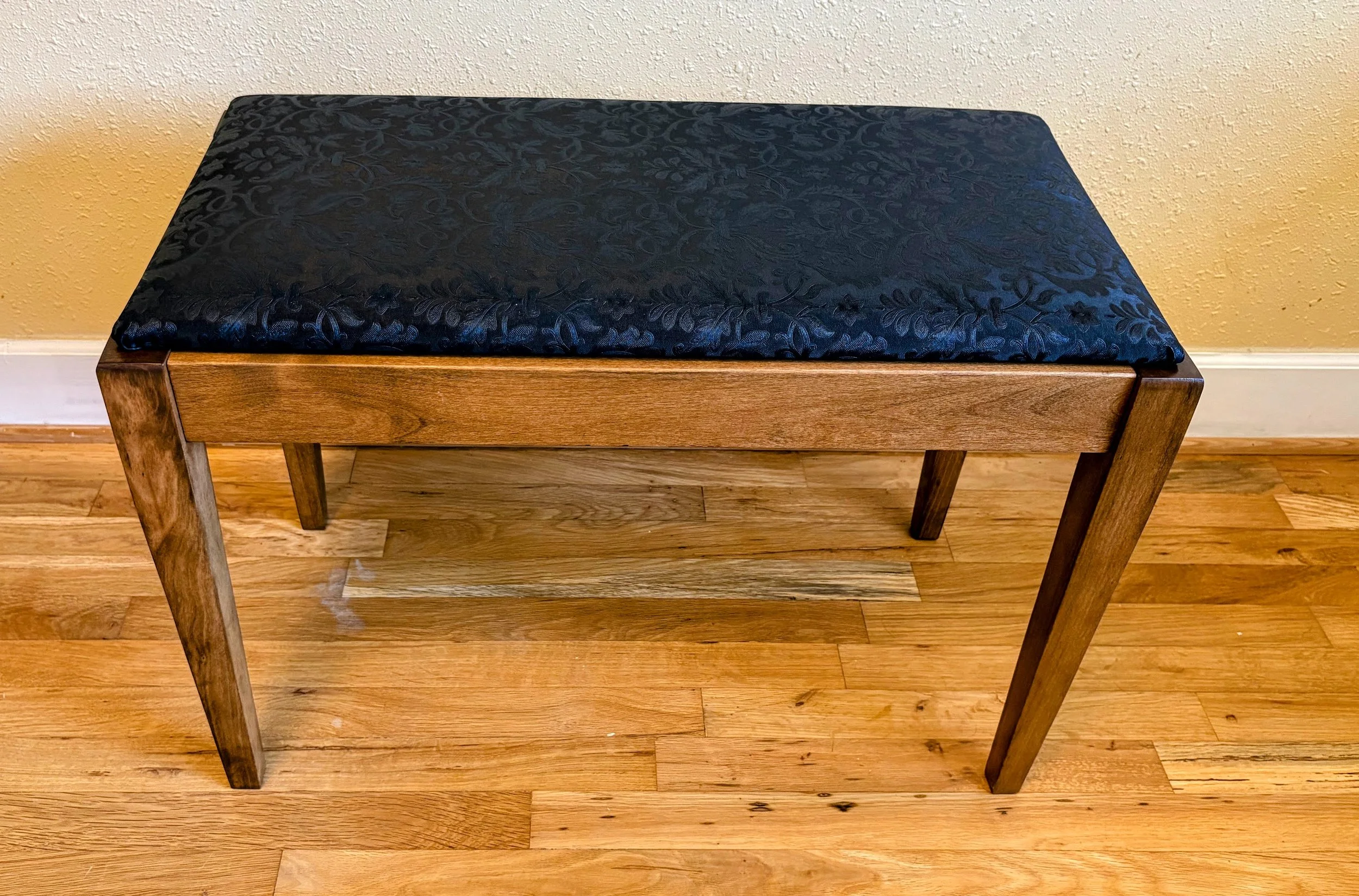 Reupholstered piano bench with storage