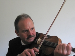 Sir Scratchy (John Landry) fiddles, sings and writes songs. He hosts "beHAVior Night—That Famous Funny Old Record Show", Friday, 5-6 pm ET, WBCQ The Planet ( www.wbcq.com ). 