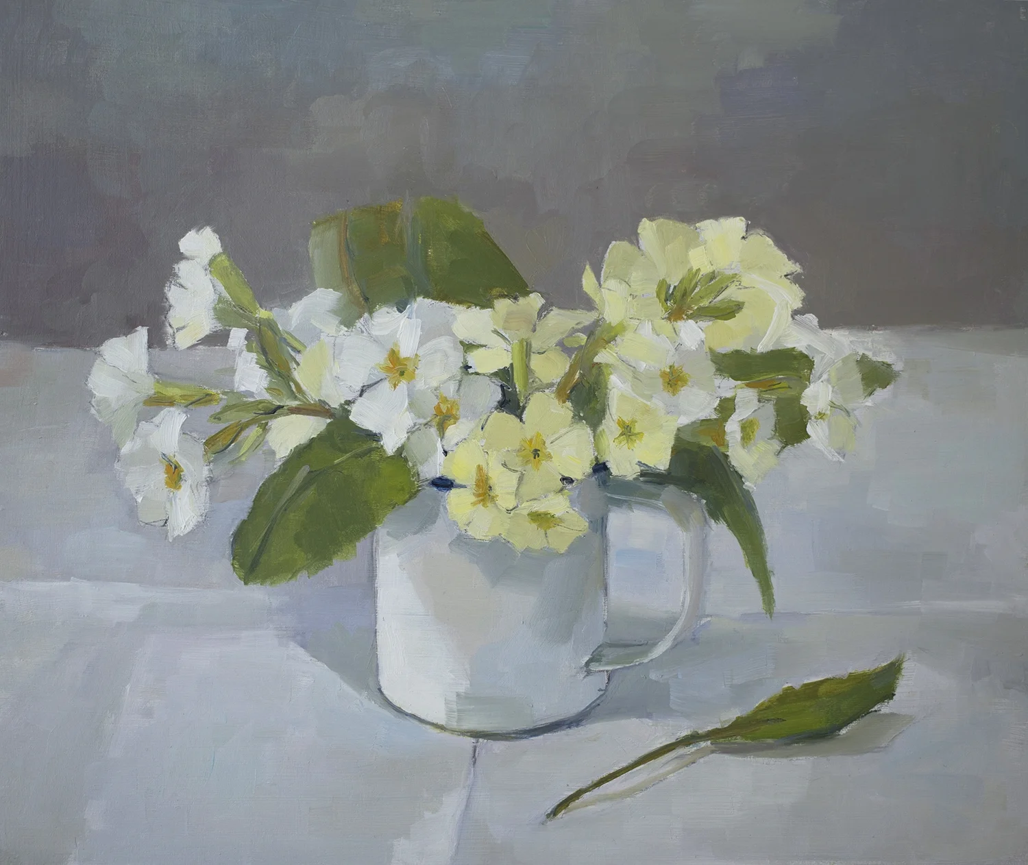 Primroses in enamel mug