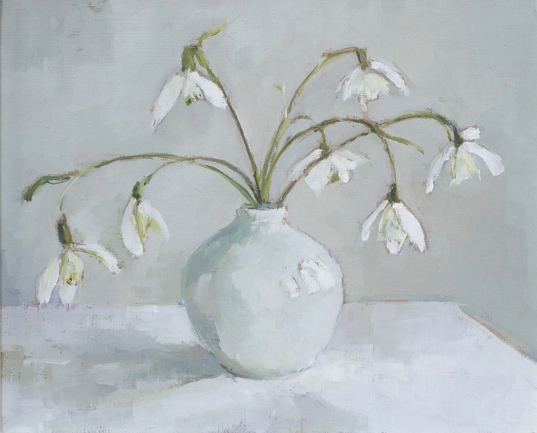 Snowdrops in pale blue round vase
