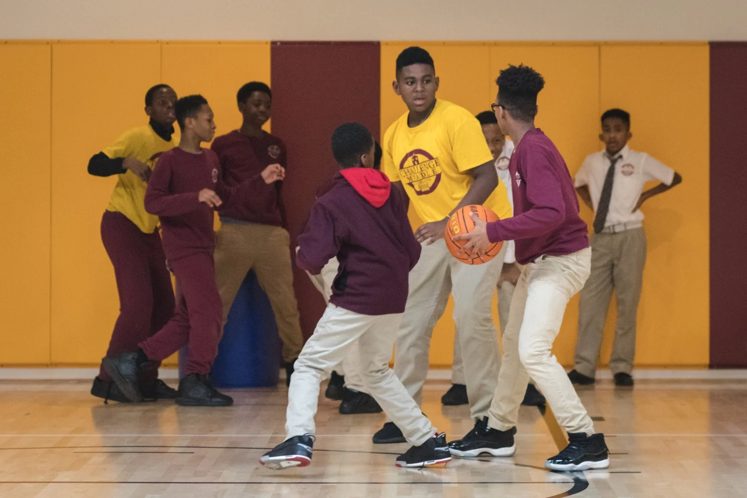 Students enjoy the playing basketball in the gym after lunch.