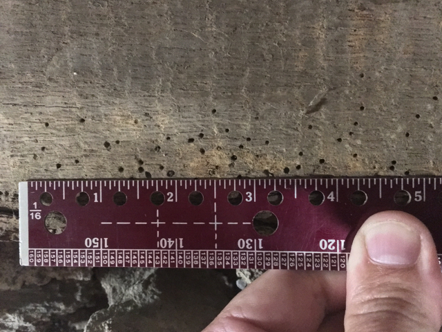 Photo 1 - Here are exit holes caused by powder post beetles on a timber in my basement.