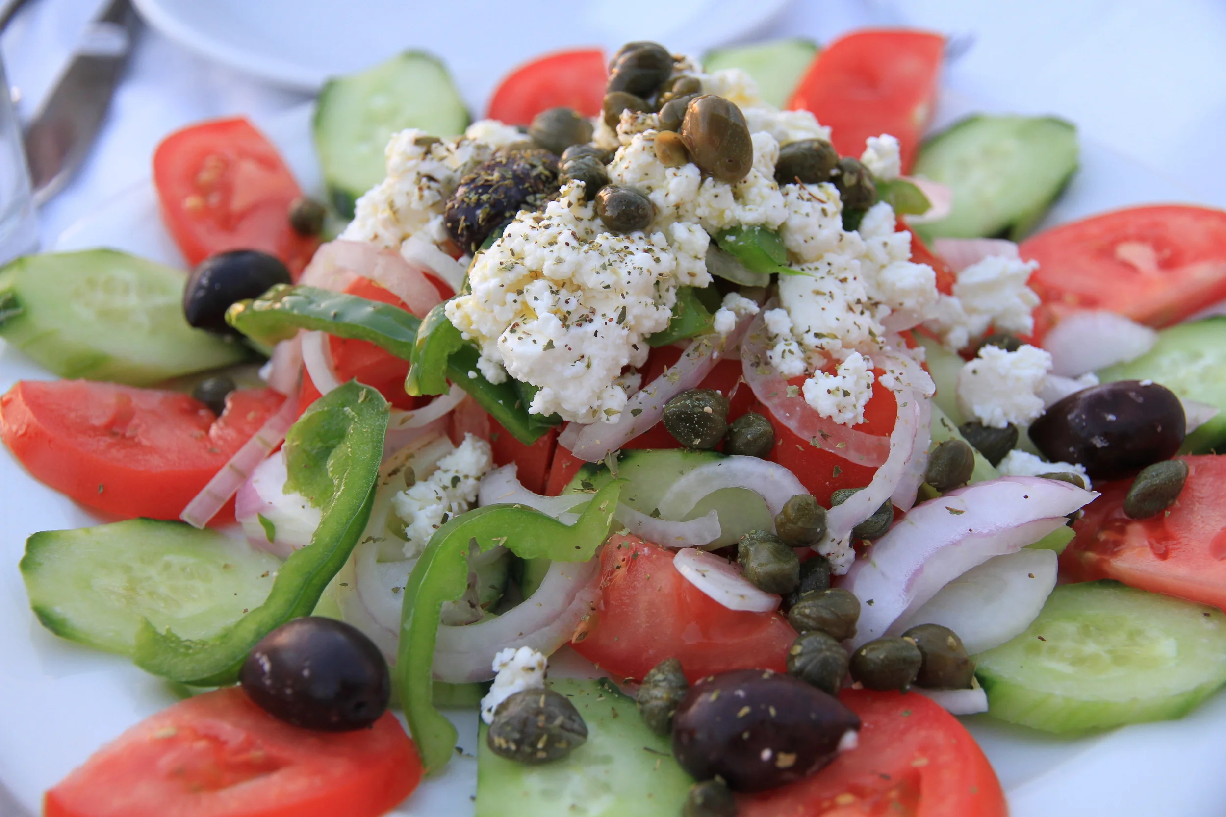 Traditional Greek salad drizzled with olive oil
