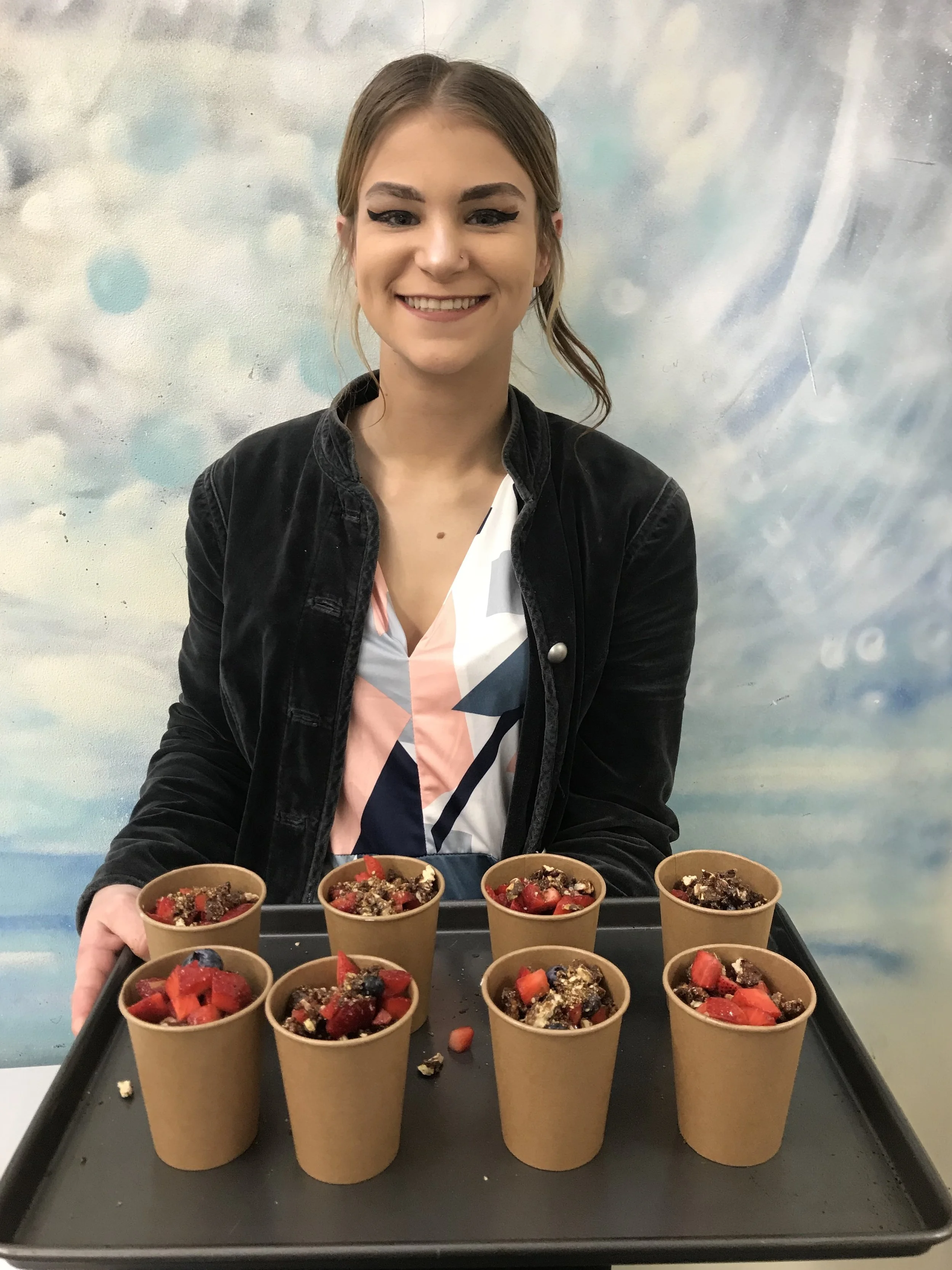 Anna a year 12 student from TLK Alesco School showing of her Greek yoghurt panna cottas made during a class