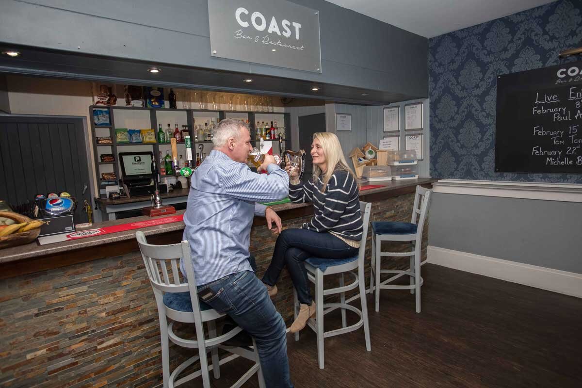 Couple enjoying a drink at the bar - Coast Bar and Restaurant.jpg