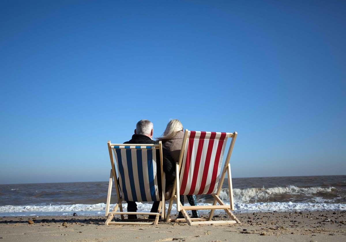 Couple sat on deckchairs on Suffolk beach.jpg