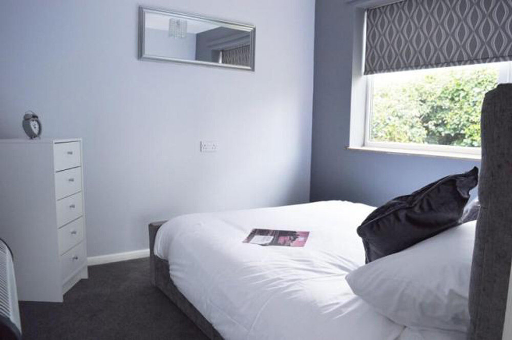 Brick built interior grey main bedroom