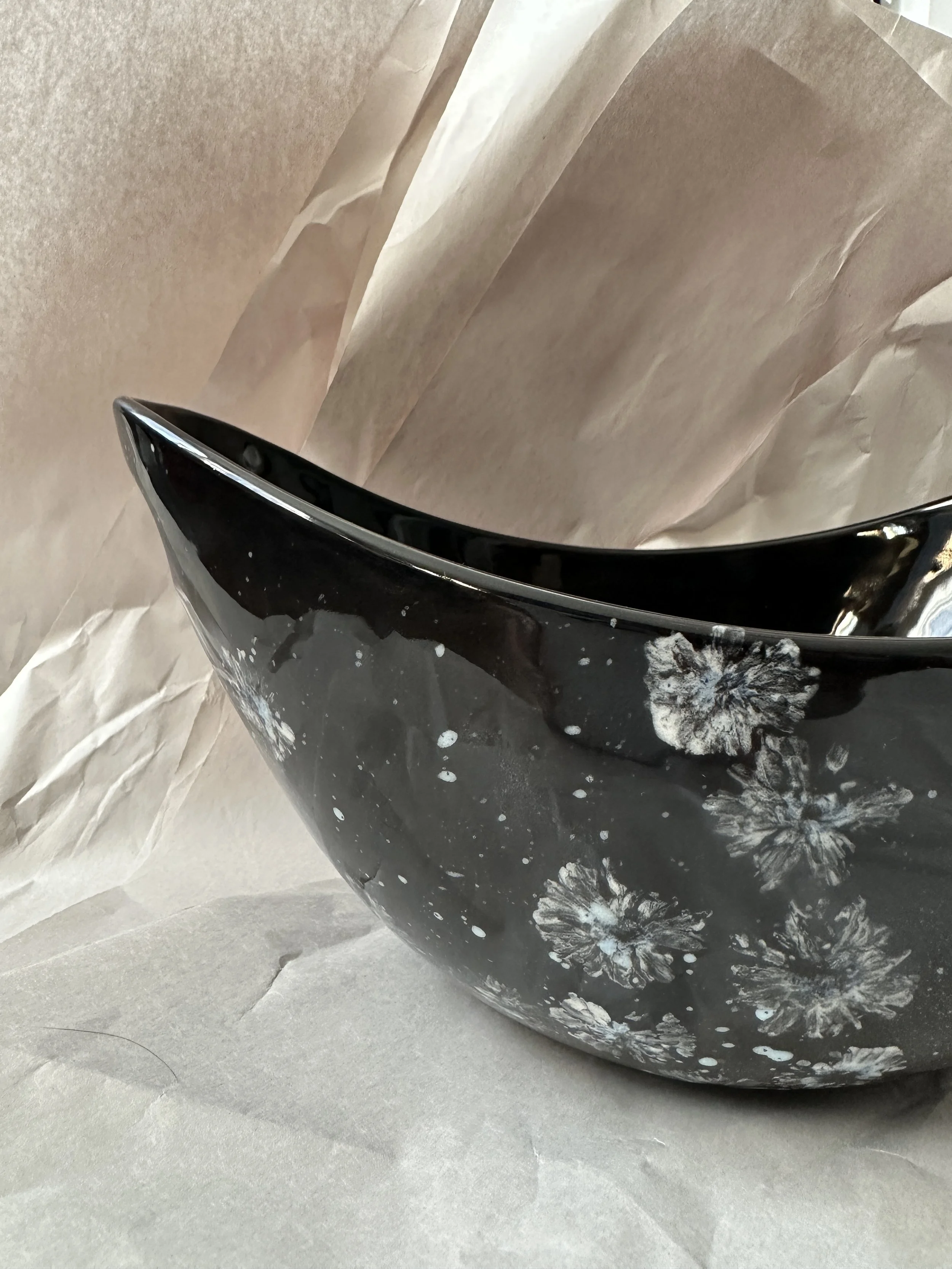  Boat shape bowl with handles 11” x 7.25” x 5.5” Daisy imprints in white, off white and a touch of blue on black ground. Food safe, dishwasher safe, but best to hand wash. 