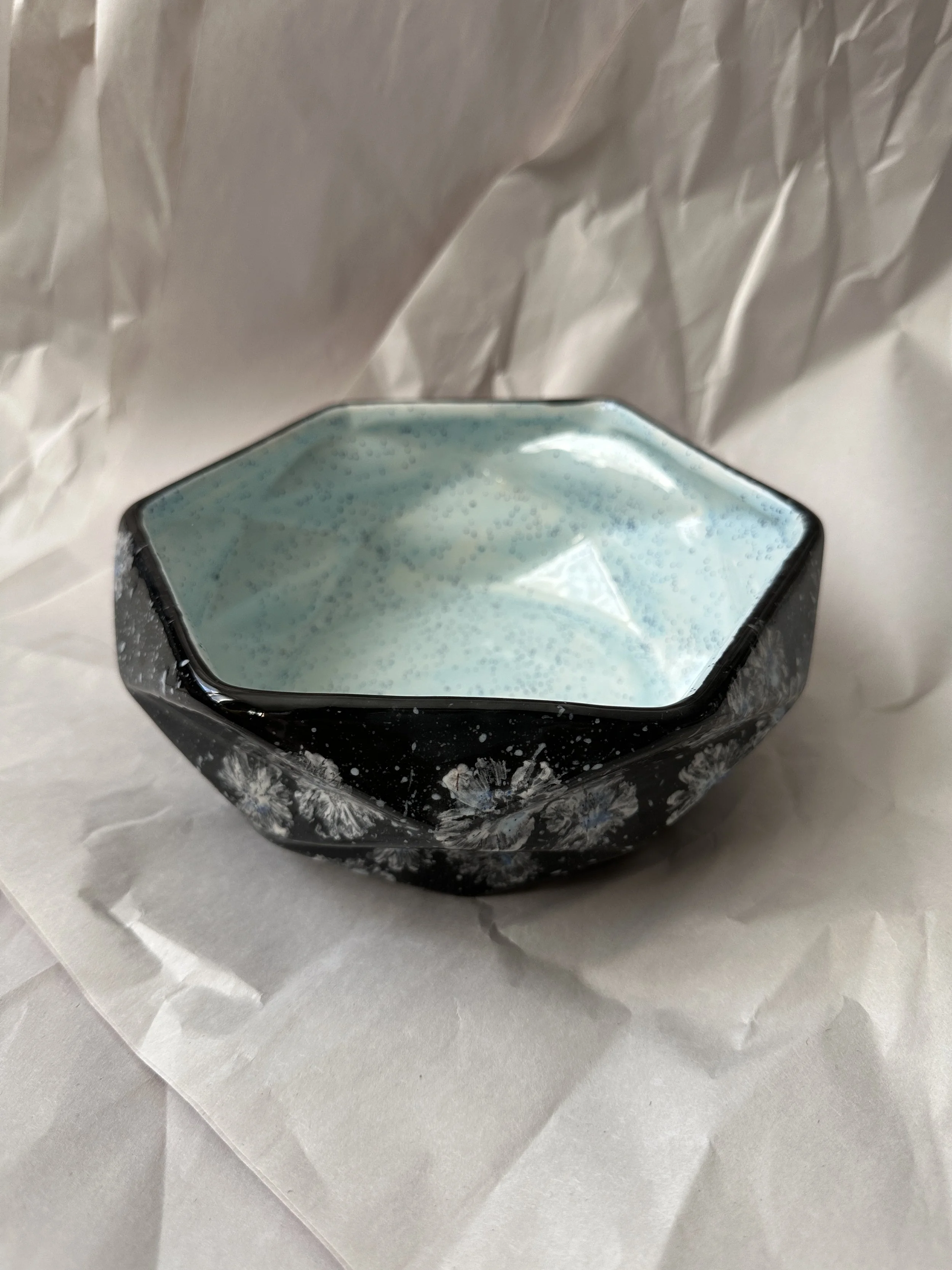  Faceted Serving Bowl 7.75” x 2.75” Daisy imprints in white, off white and a touch of blue on black ground.Food safe, dishwasher safe, but best to hand wash. 