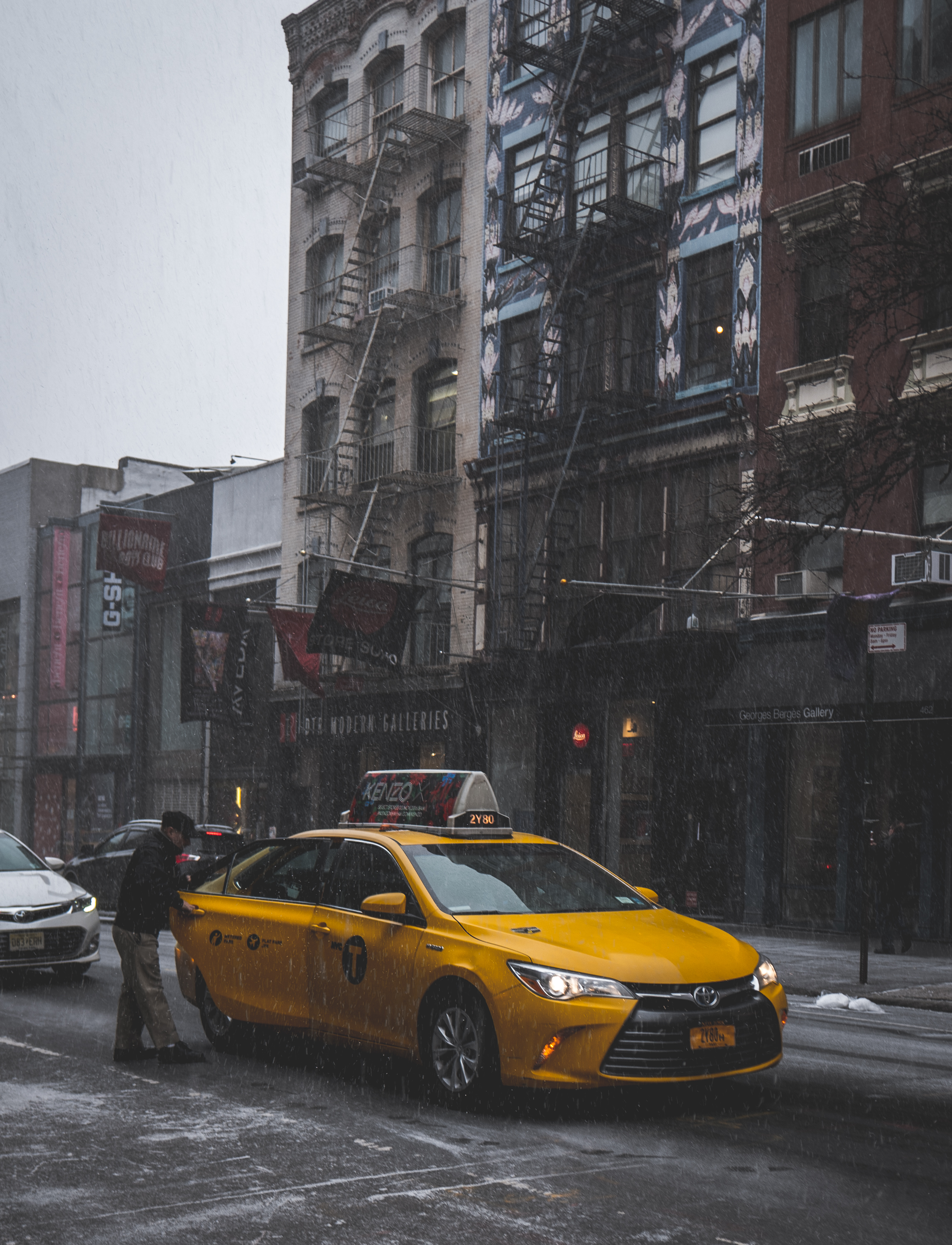 A classic "New York" photo of man getting into yellow cab. Love the pop of yellow from the cab in this otherwise desaturated dark toned photo. 