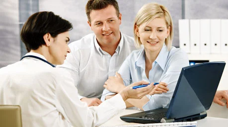 primary care doctor sitting with patients