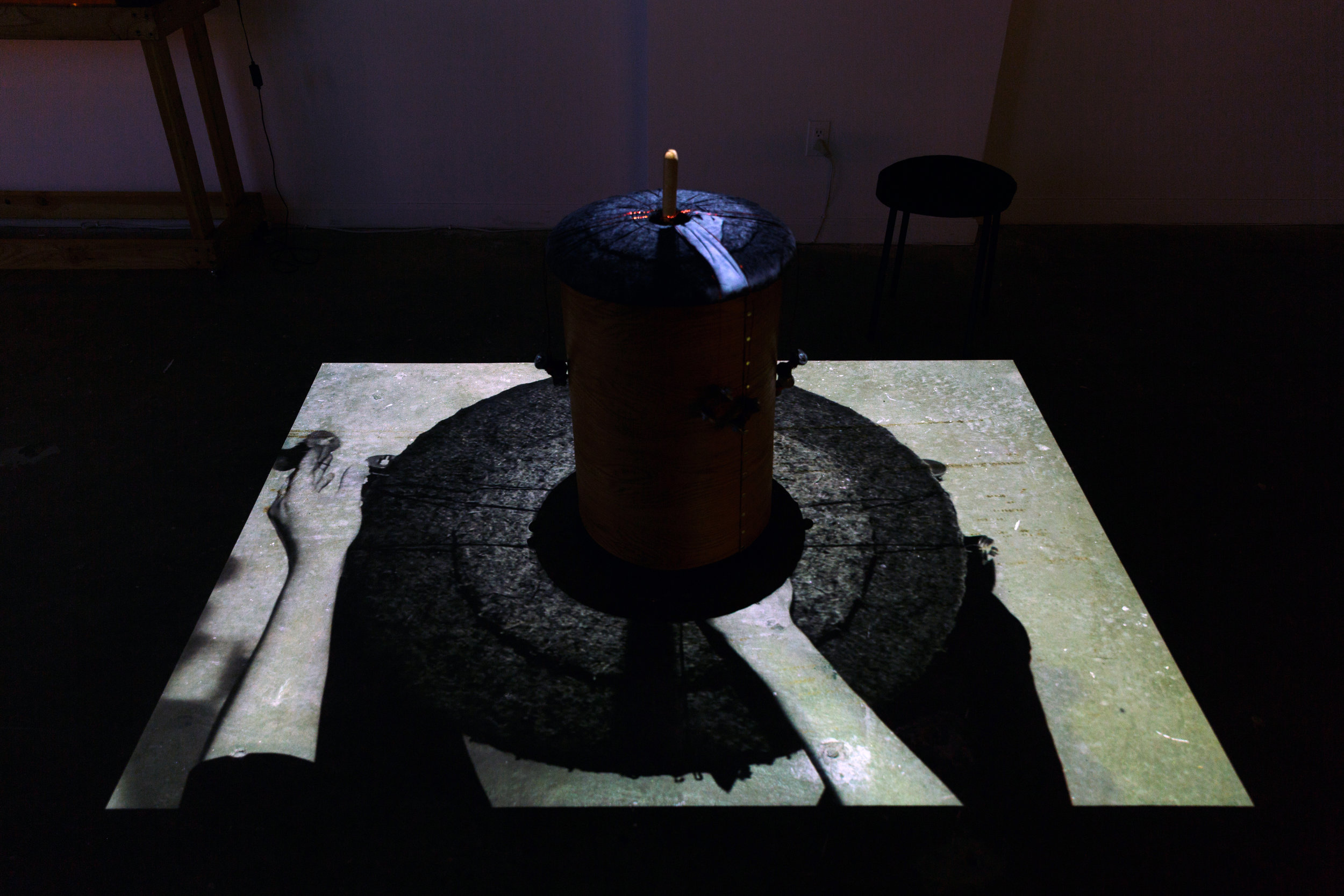   Interior gallery installation view 4    Detail:  Braiding table with overhead video projection of hands making braids.  