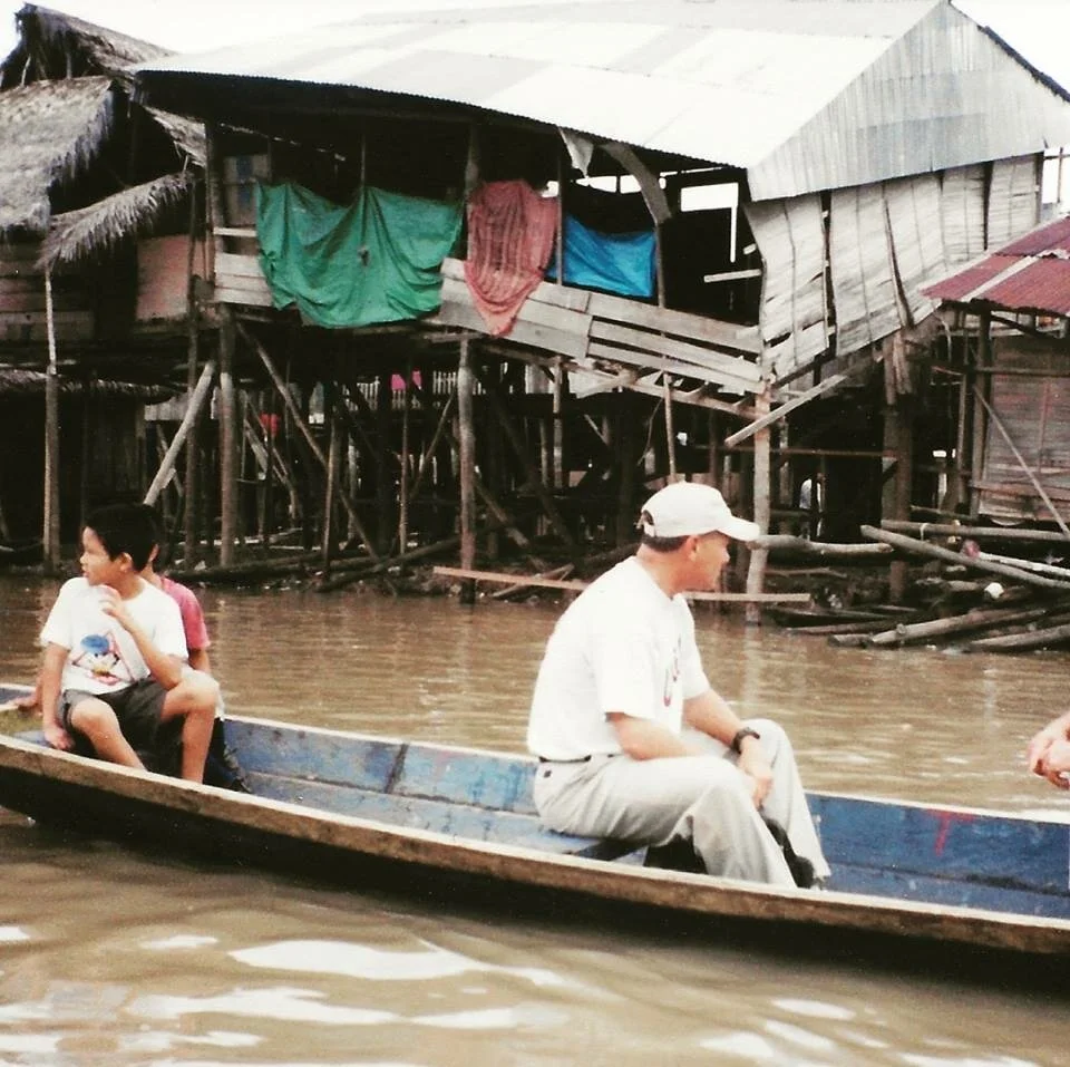 Charlie Craig on a boat in the Peruvian Amazon