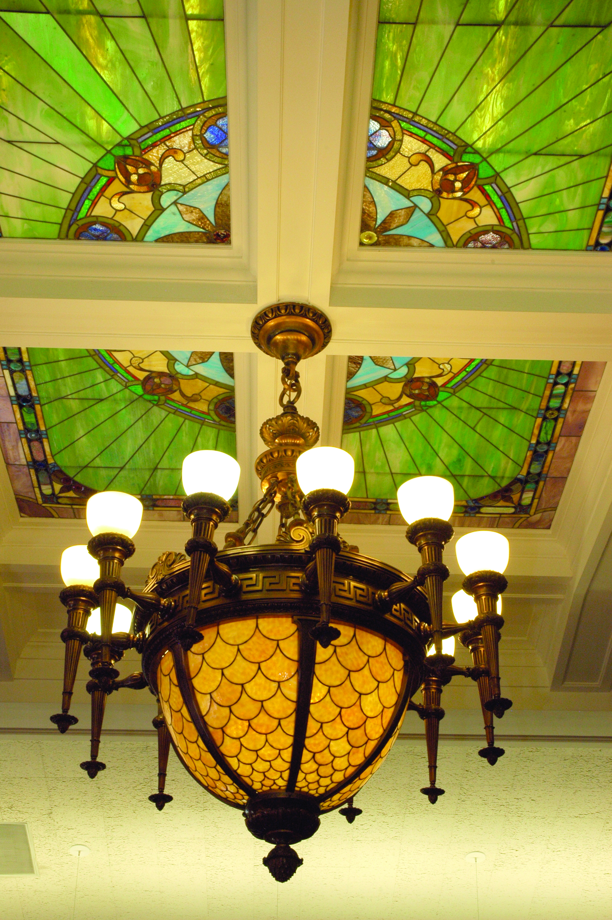 The Supreme Court chandelier in Room 302 is one of the oldest and most elaborate chandeliers in the Capitol and hung beneath the stained glass lay-light in the middle of the hearing room.