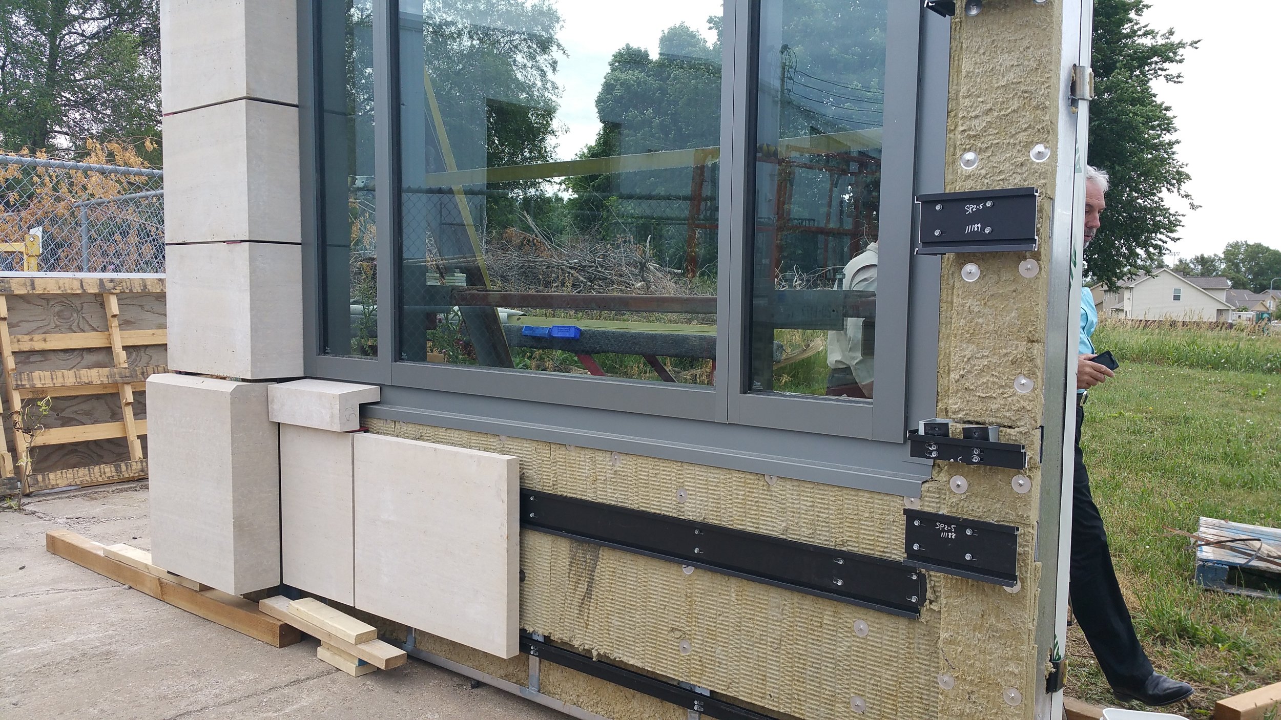 Stone will be installed after the wall panels are secured to the building. Here is an example of how the stone will be placed on the panels.