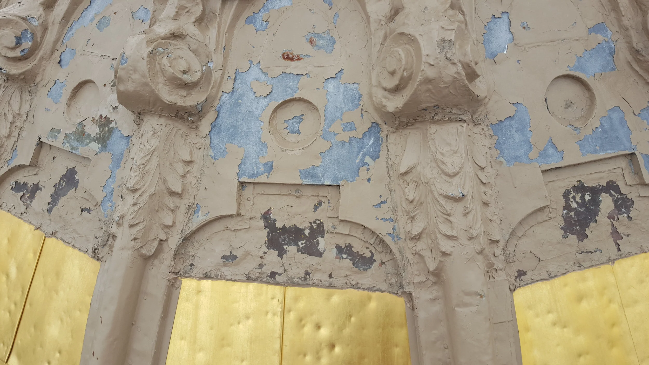 Hail damage and deterioration of materials are evident on the dome.