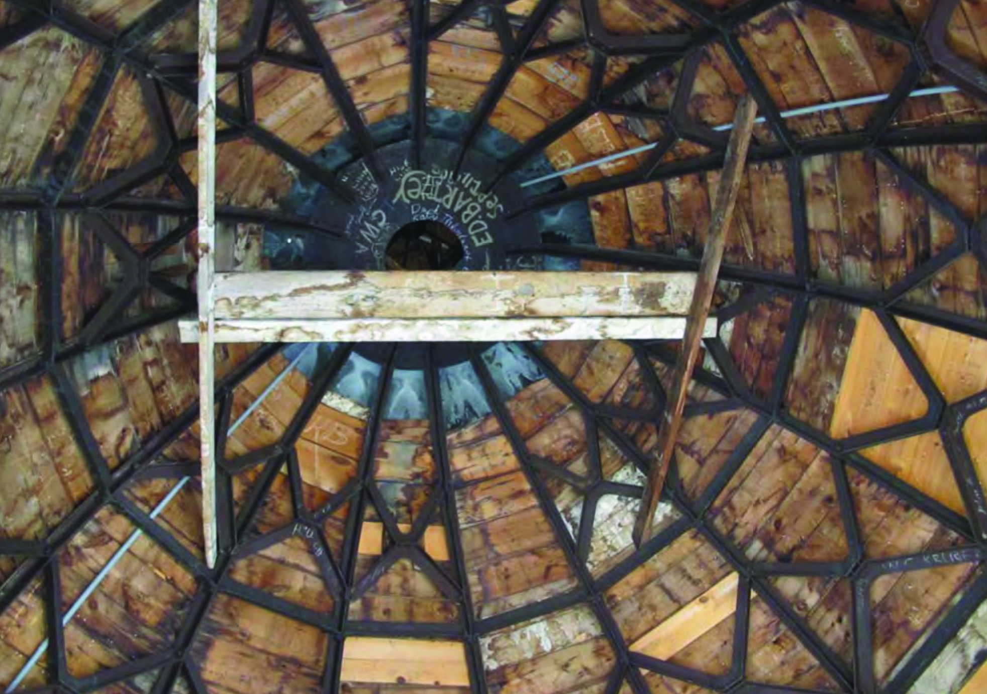 Widespread moisture damage is shown on the underside of the dome wood decking. 