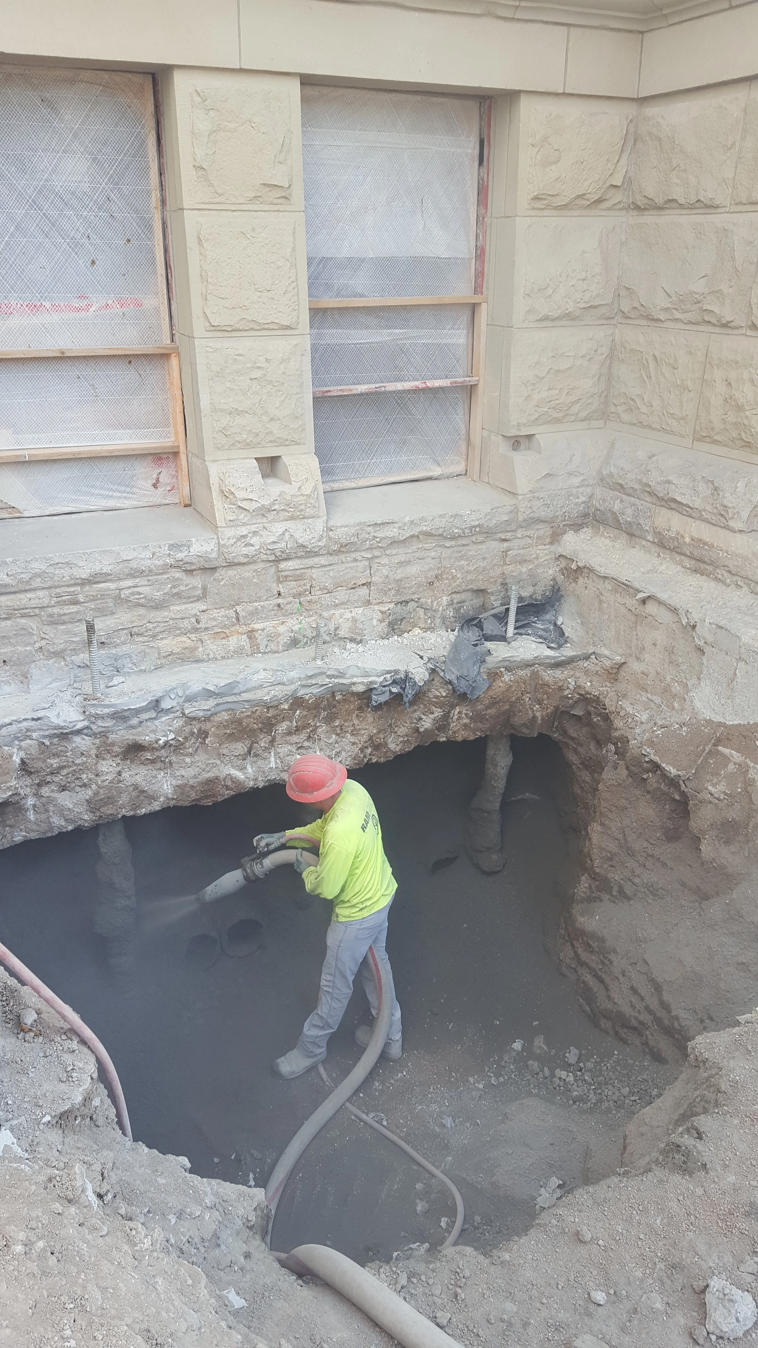 Straightline spraying gypcrete on west of north stairs micropiles.jpg