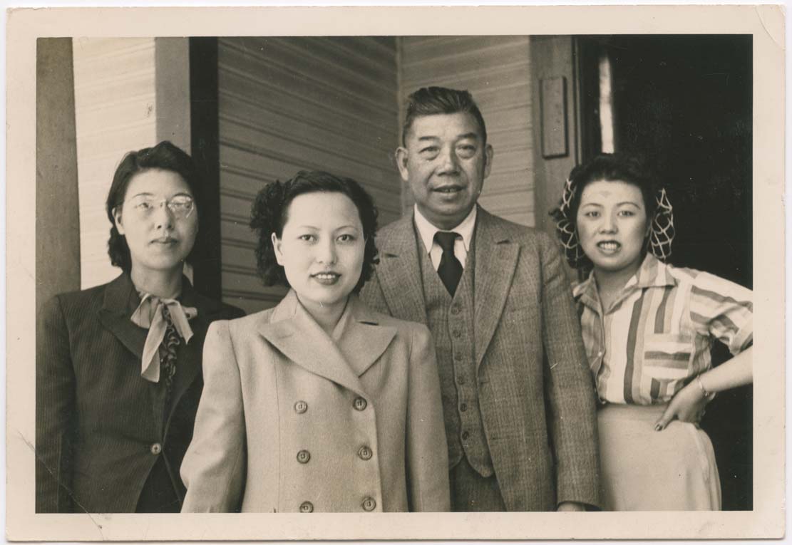 IRENE LUM (CENTRE LEFT) WITH HER "PAPER FAMILY," THE WONGS. PHOTOGRAPHED BY JIM WING YUEN. 1940-1941. VICTORIA, BRITISH COLUMBIA. GELATIN SILVER PRINT. GIFT OF THE LUM FAMILY. COURTESY OF THE FAMILY CAMERA NETWORK AND THE ROYAL ONTARIO MUSEUM.