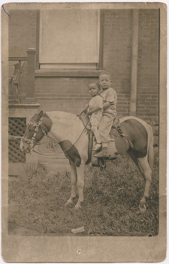 Norman H. Lee (Diddy) and Frank Newton Lee Jr. (Newtie), on a pony near St. Patrick Street. Around 1920. Unknown Photographer. Toronto, Ontario. Gelatin silver print. Gift of Nancy M. Lee. Courtesy of The Family Camera Network and the Royal Ontario Museum. 2018.31.2. (Photo: 2017 © ROM)