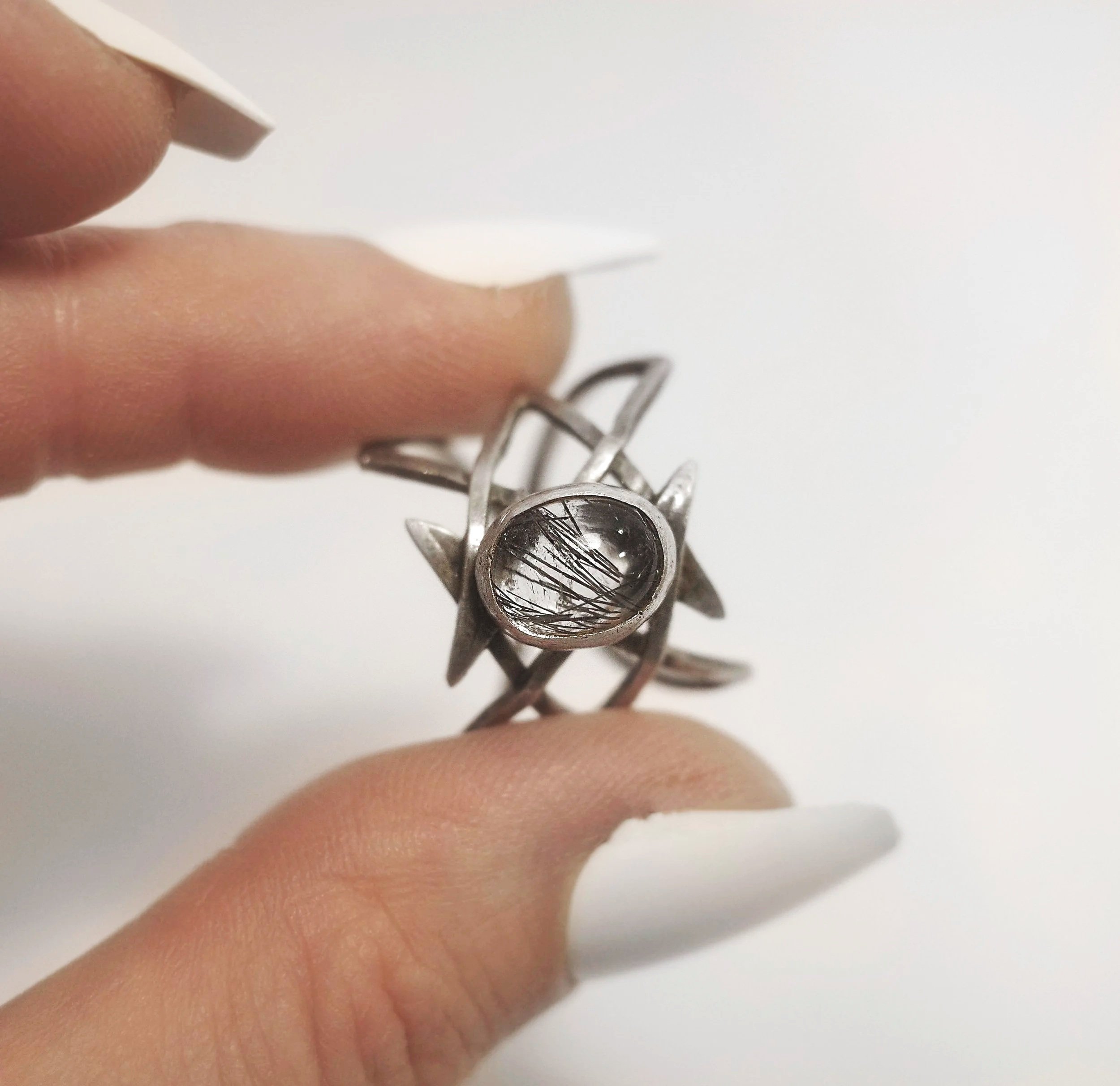 Rutilated+quartz+lattice+ring+held.jpg