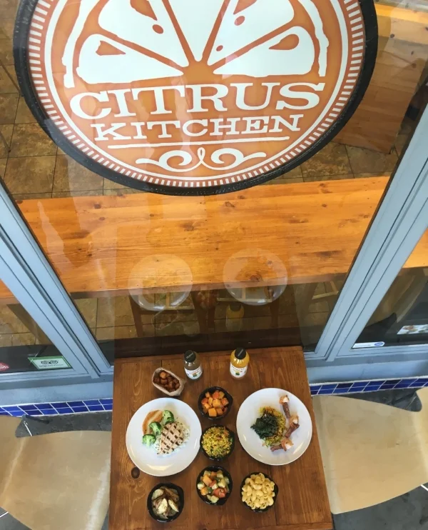 Left Plate: Citrus Chicken with a side of steamed broccoli. Sides: Butternut Squash Saute, Cous-Cous, Local Vegetables. Garlic Potatoes. ,Mac N Cheese. Right Plate: Tri-Tip Cous-Cous and Kale and Quinoa