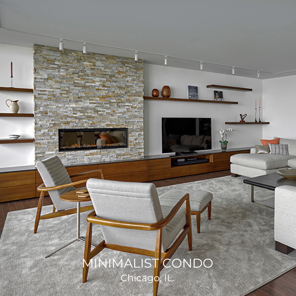 Modern minimalist living room with a stone fireplace, wall-mounted shelves, gray chairs, sofa, TV, and dark wood furniture, located in a Chicago condo.
