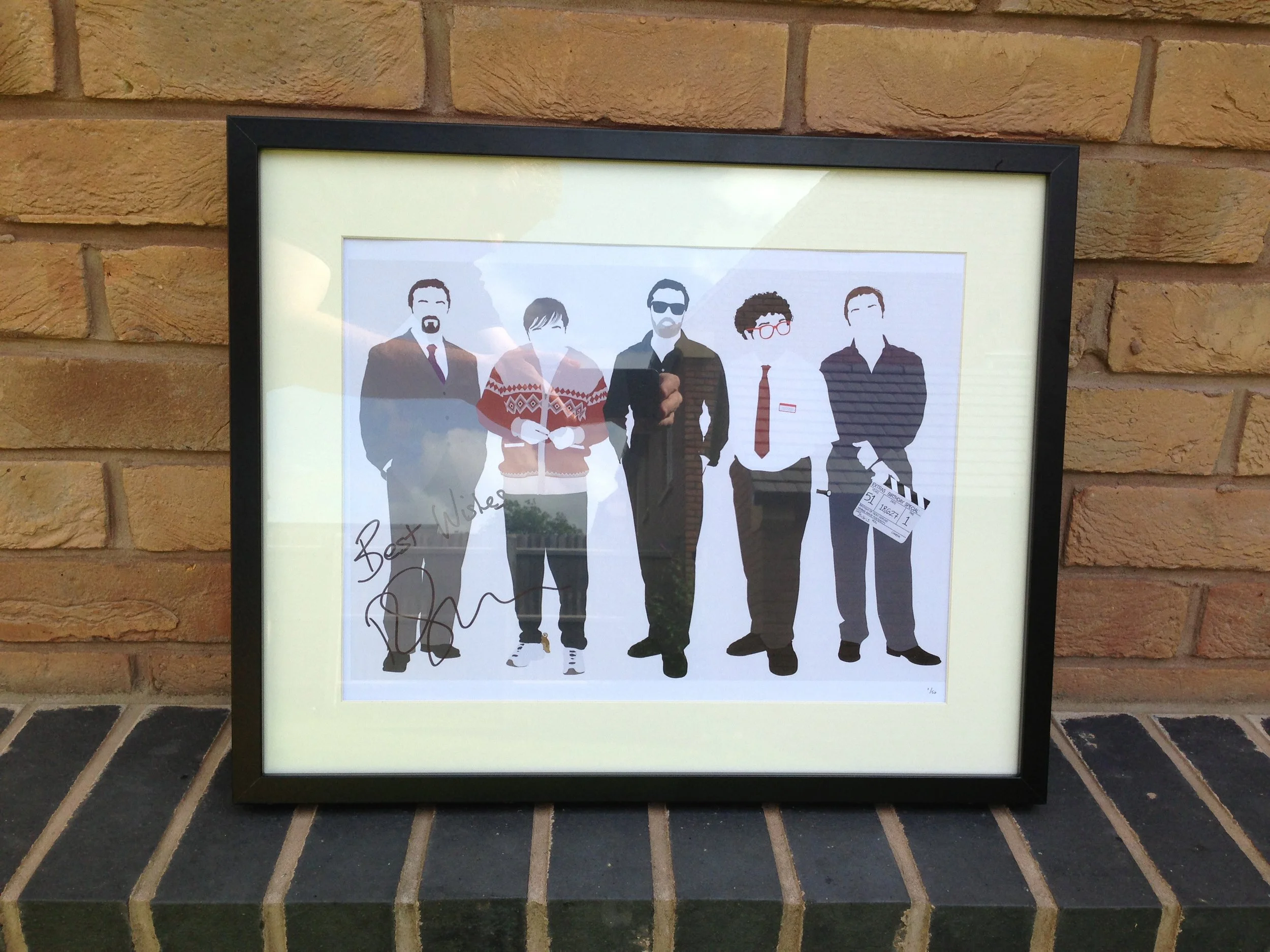 A framed illustration of five men standing in a row, dressed in various outfits including suits, casual jackets, and a white shirt with a red tie, with a brick wall background.