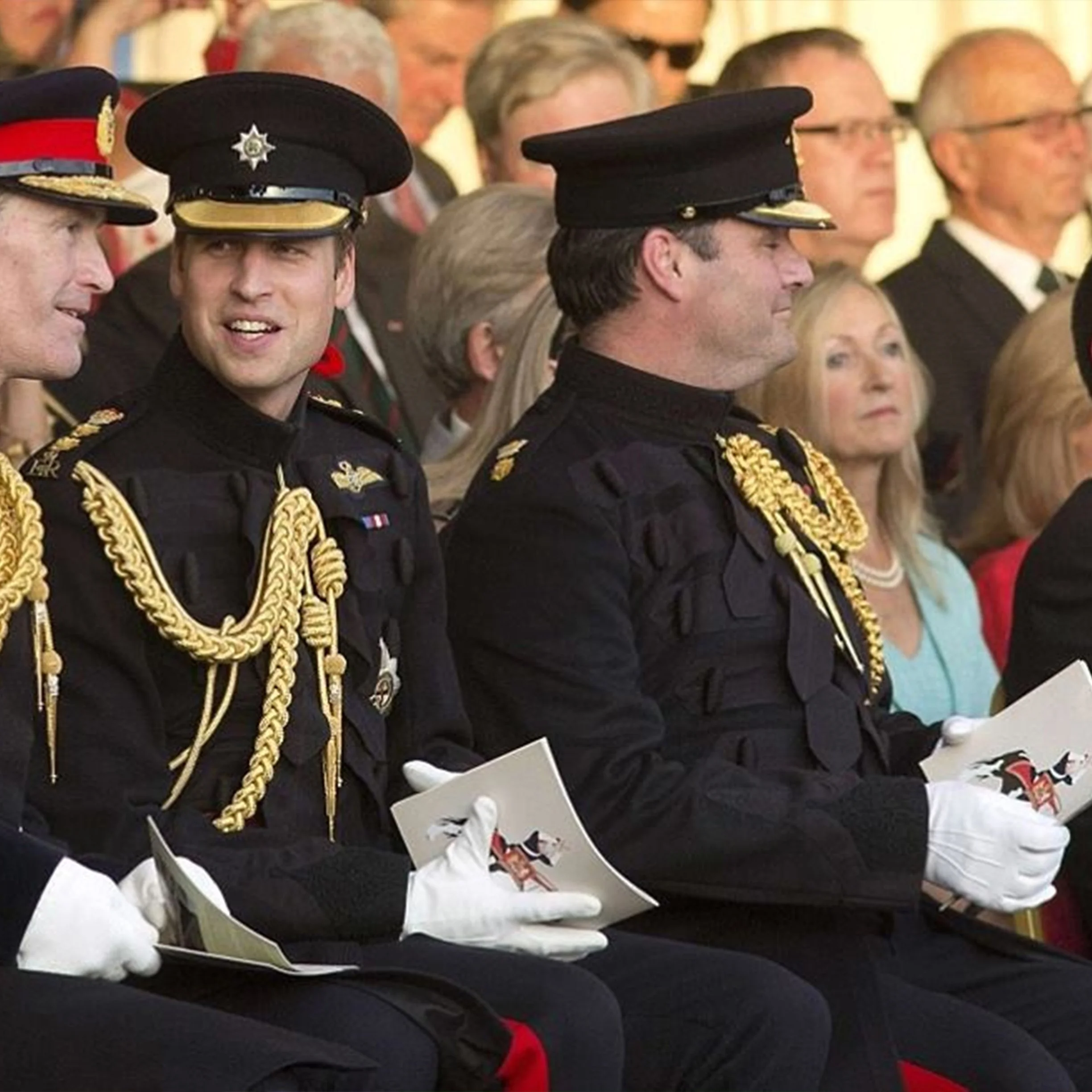 Group of men dressed in formal military uniforms with gold braids and medals, attending a ceremony or official event.